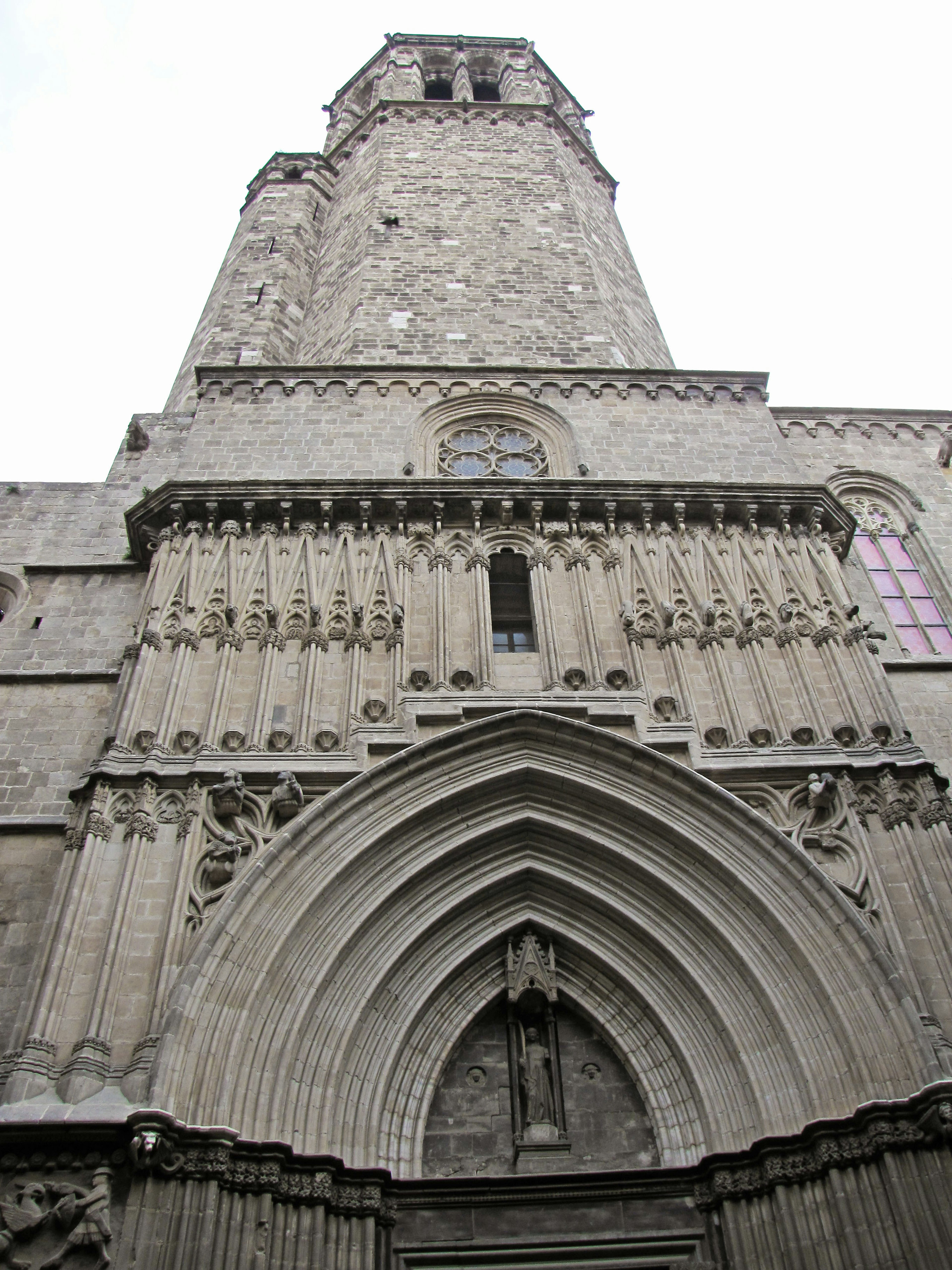 Historisches Gebäude mit einem Turm und dekorativer Fassade von unten betrachtet