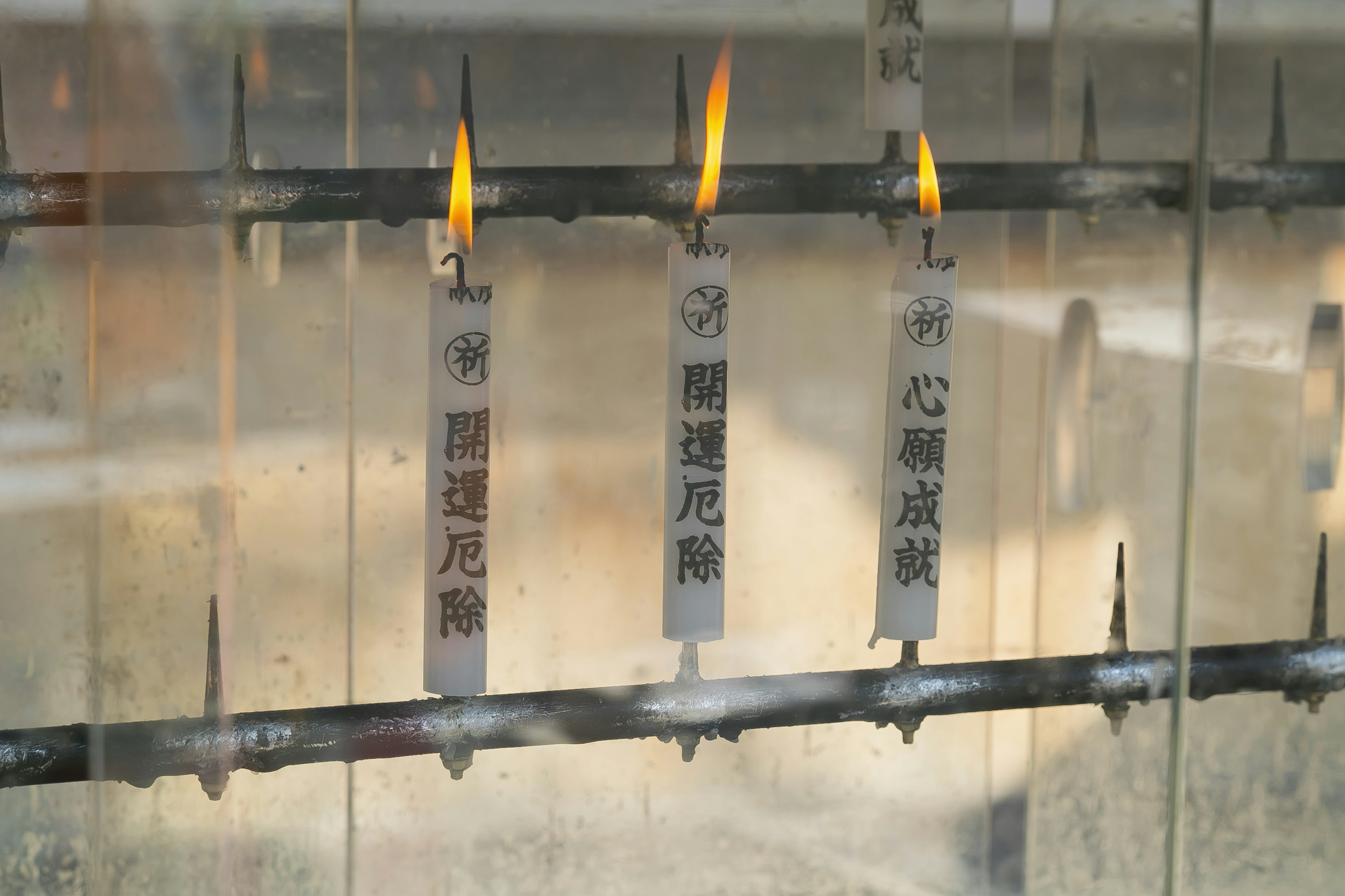 A serene scene of lit candles in a shrine