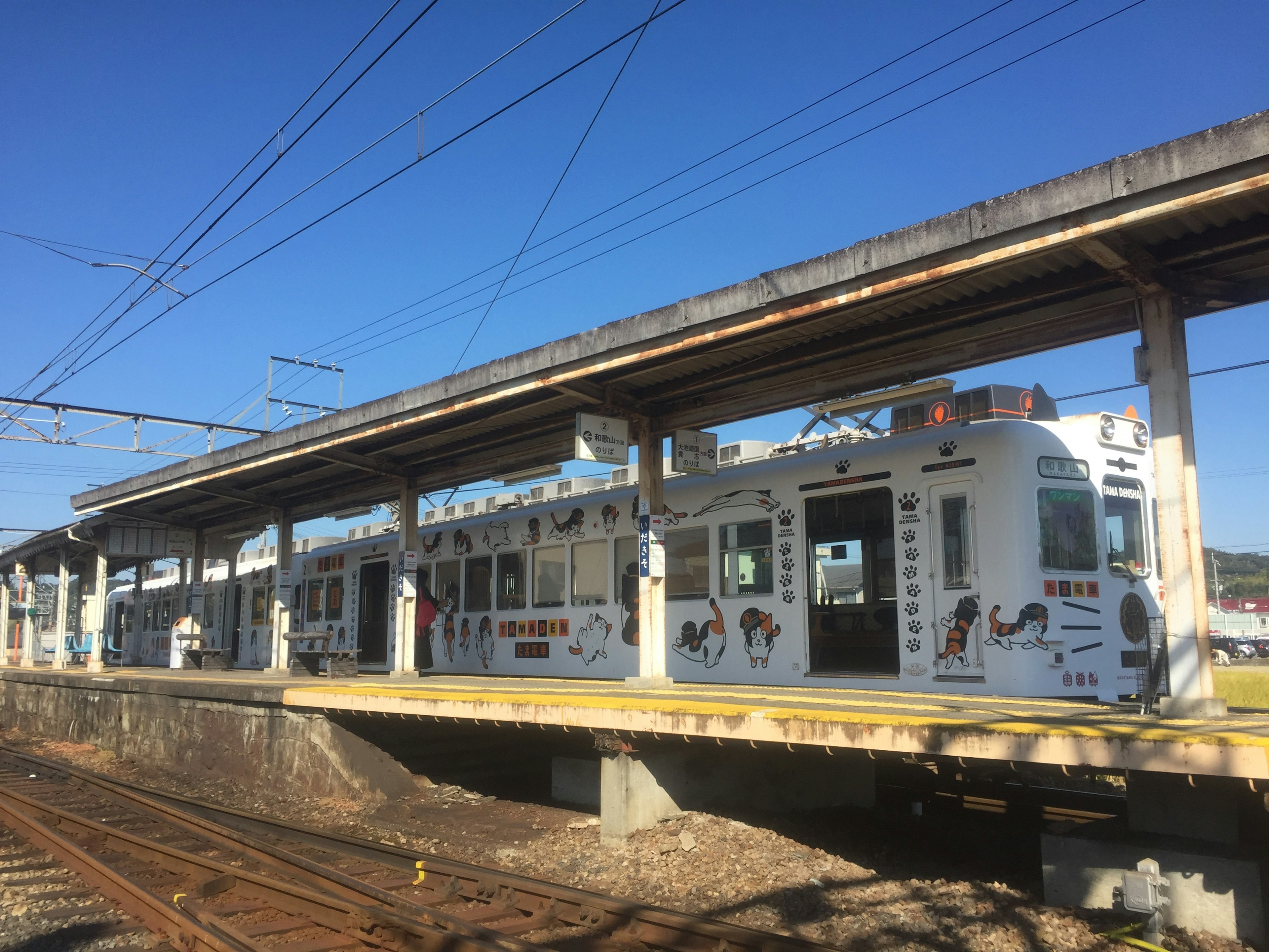 Decoratively designed train at a train station under a clear blue sky