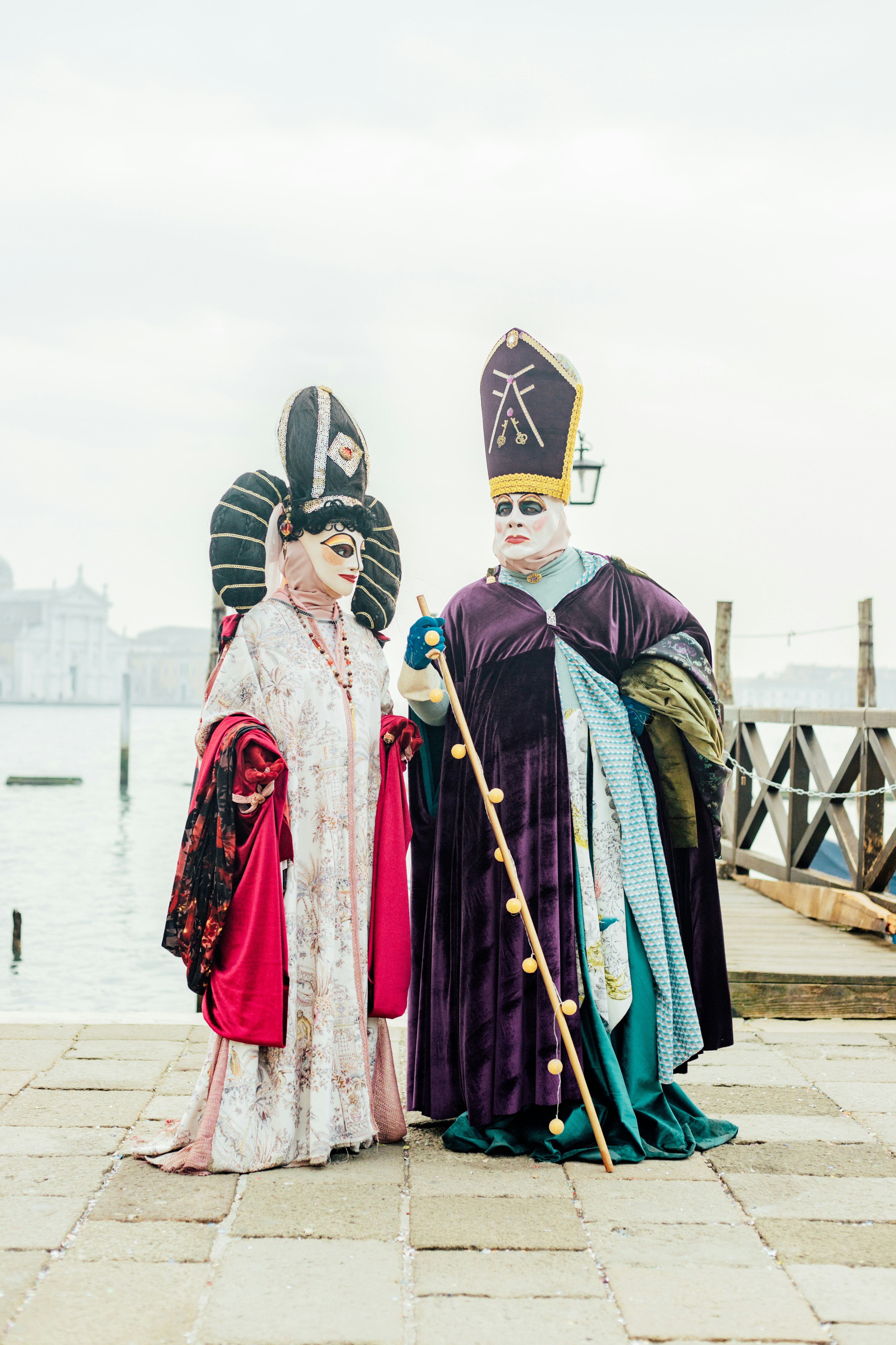 Two individuals in elaborate costumes at the Venice Carnival