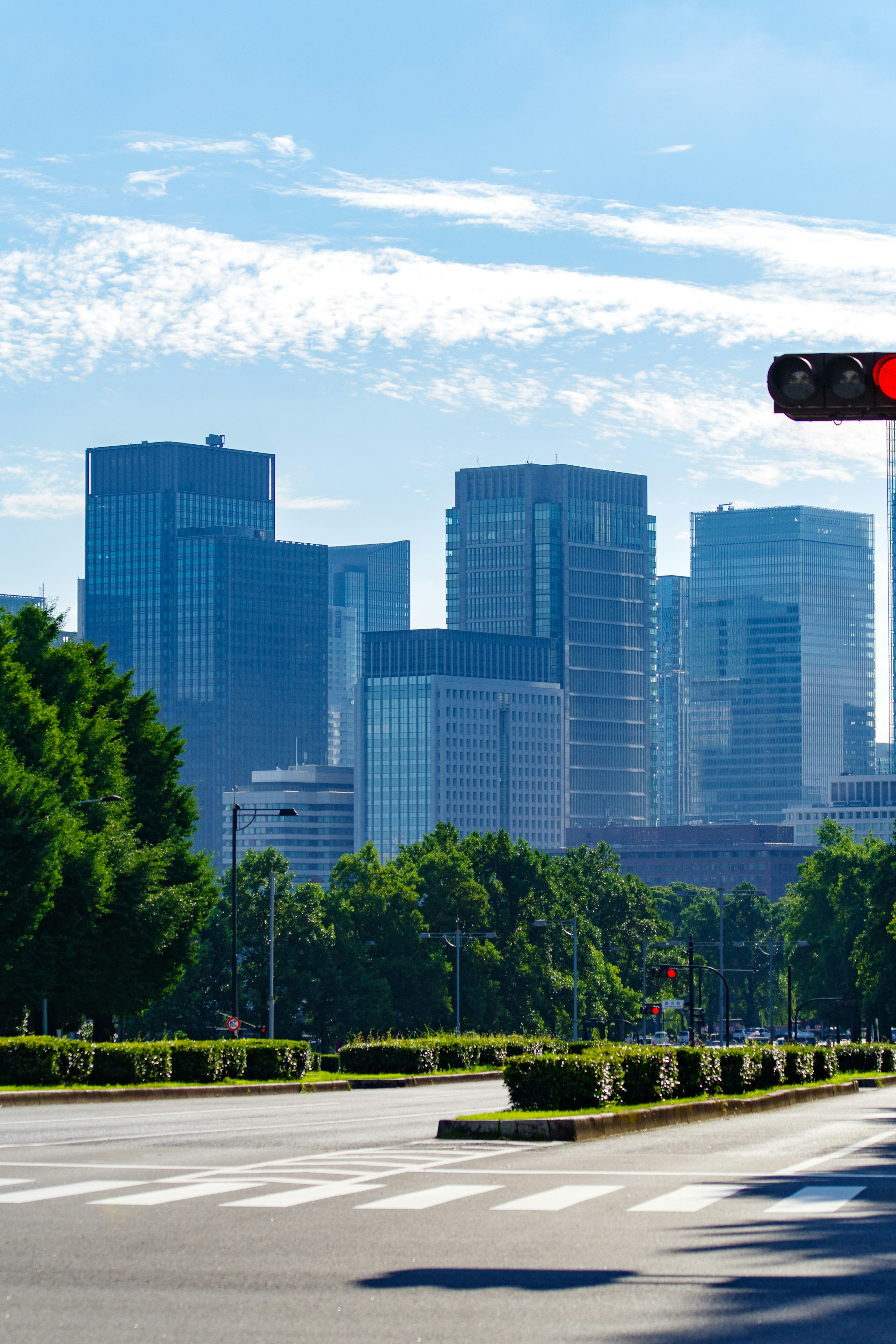 City skyline under blue sky with green landscaping