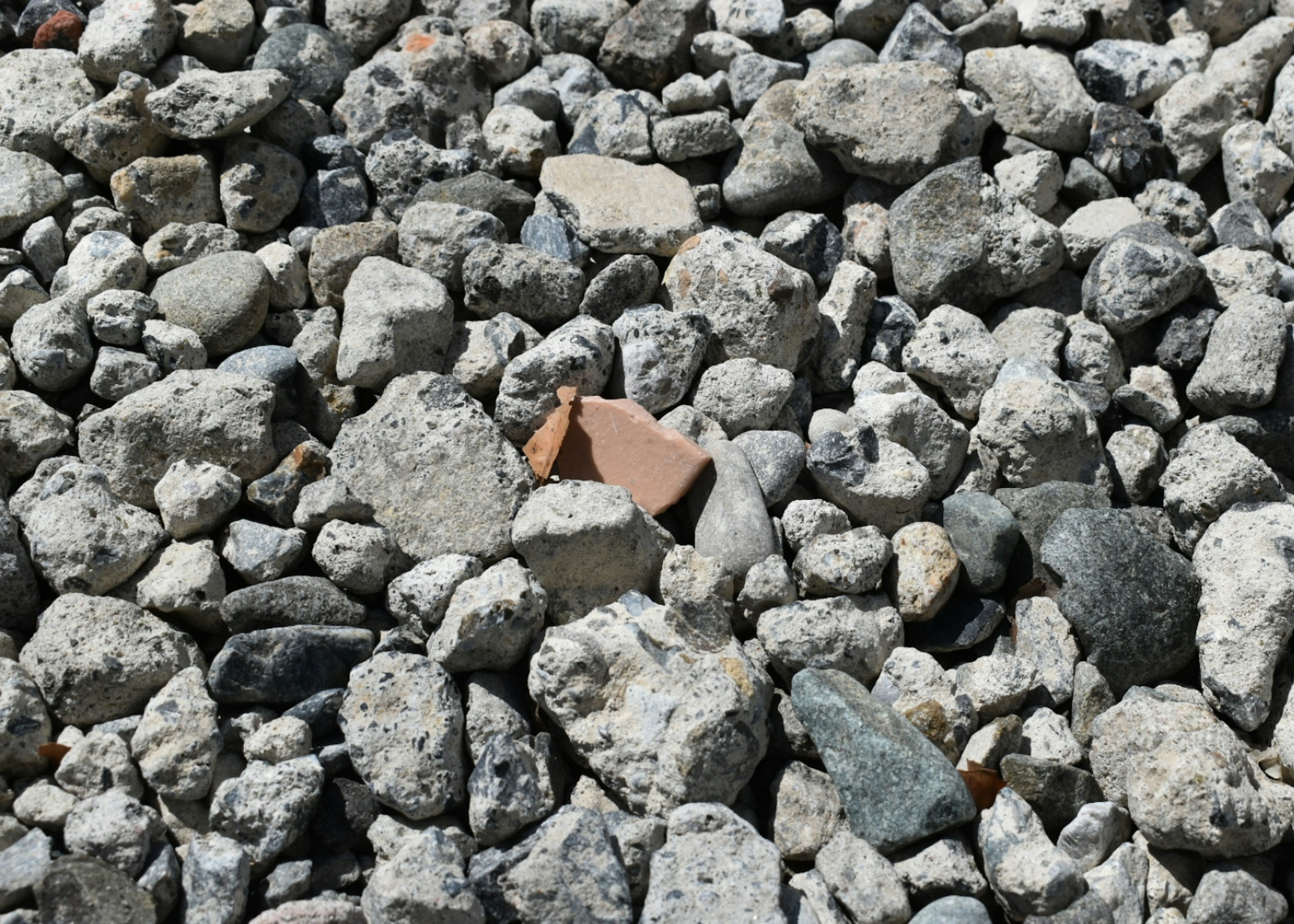 A collection of various sizes of gray stones and rocks