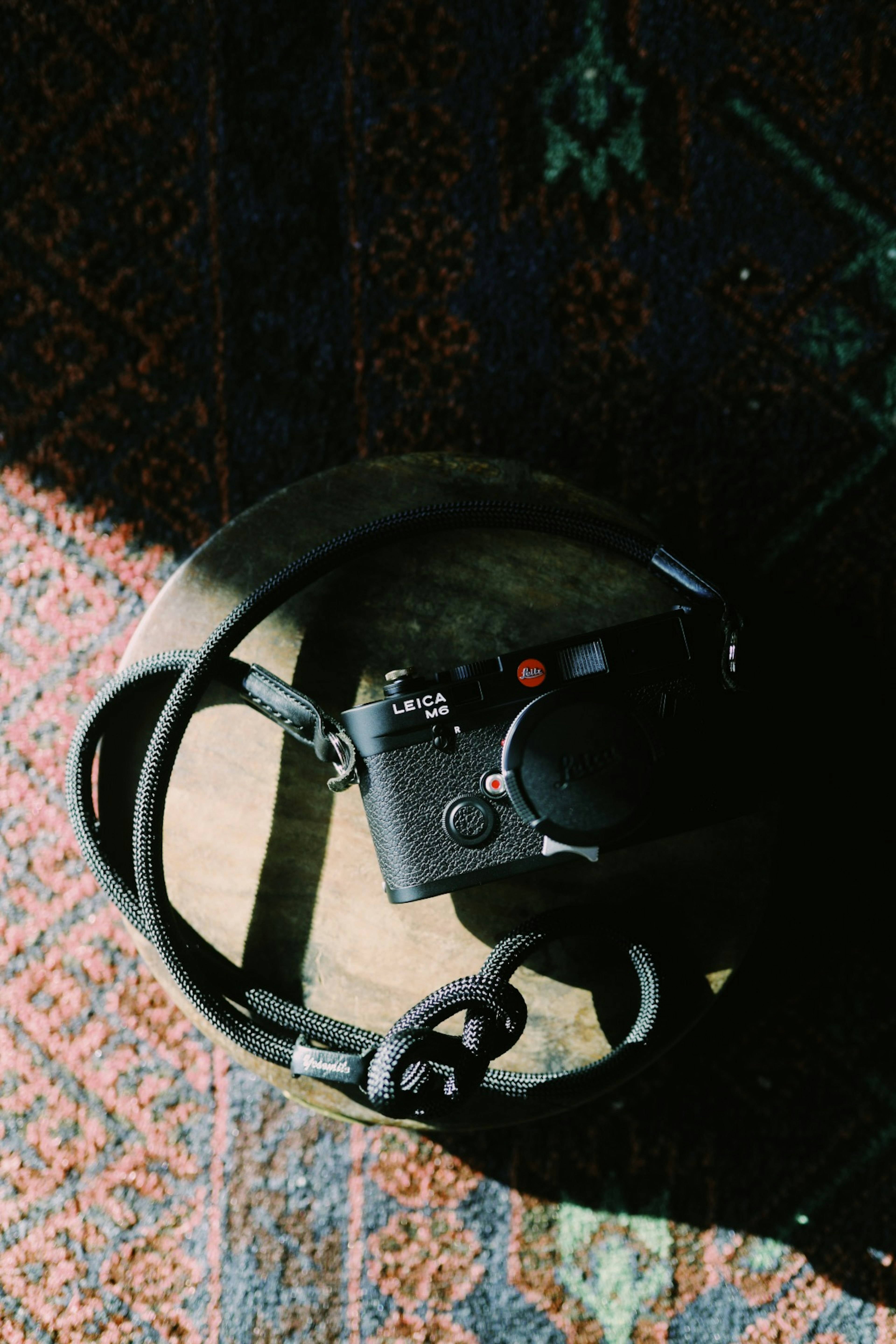 A camera and headphones placed on a wooden table