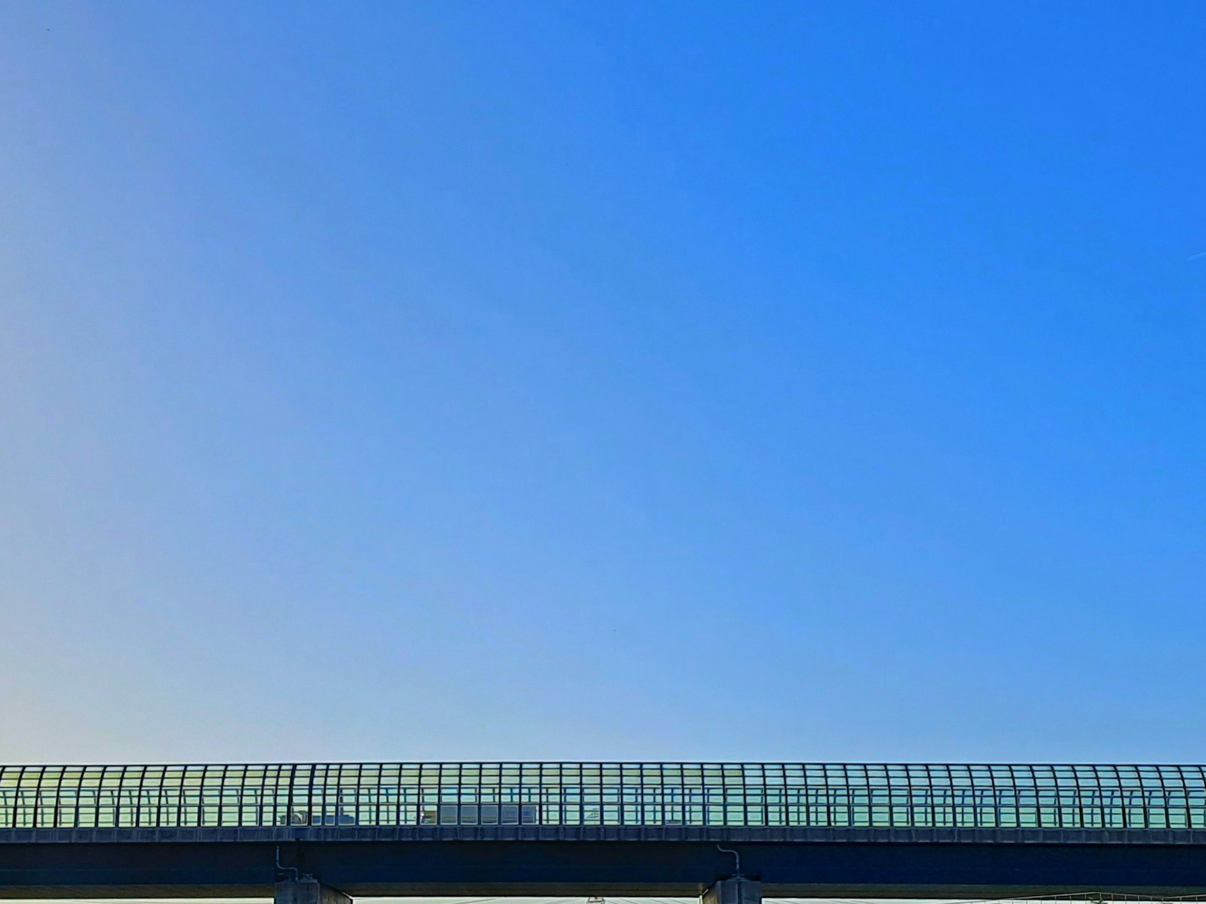 Structure with a glass roof under a blue sky