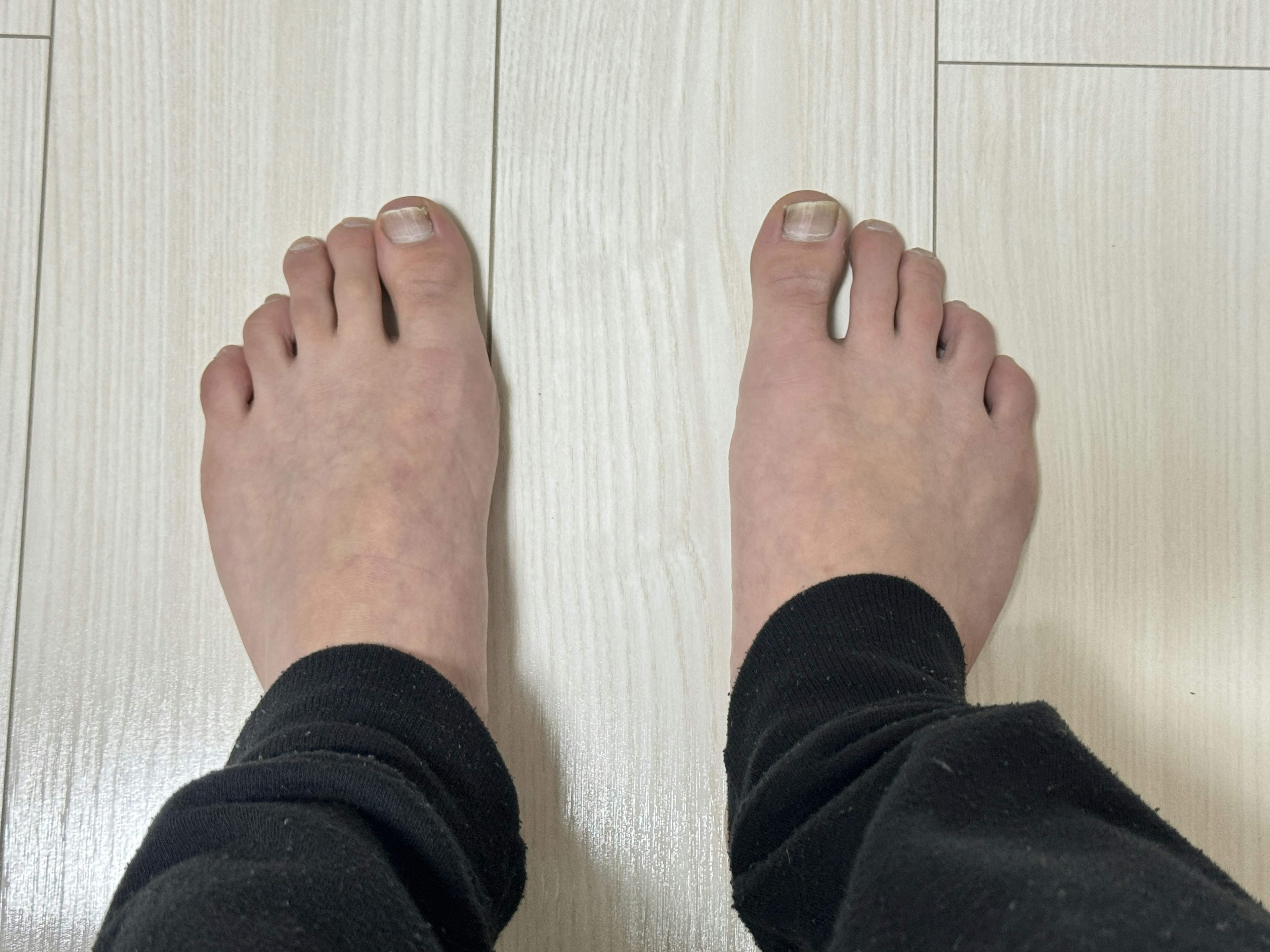 Bare feet on wooden flooring