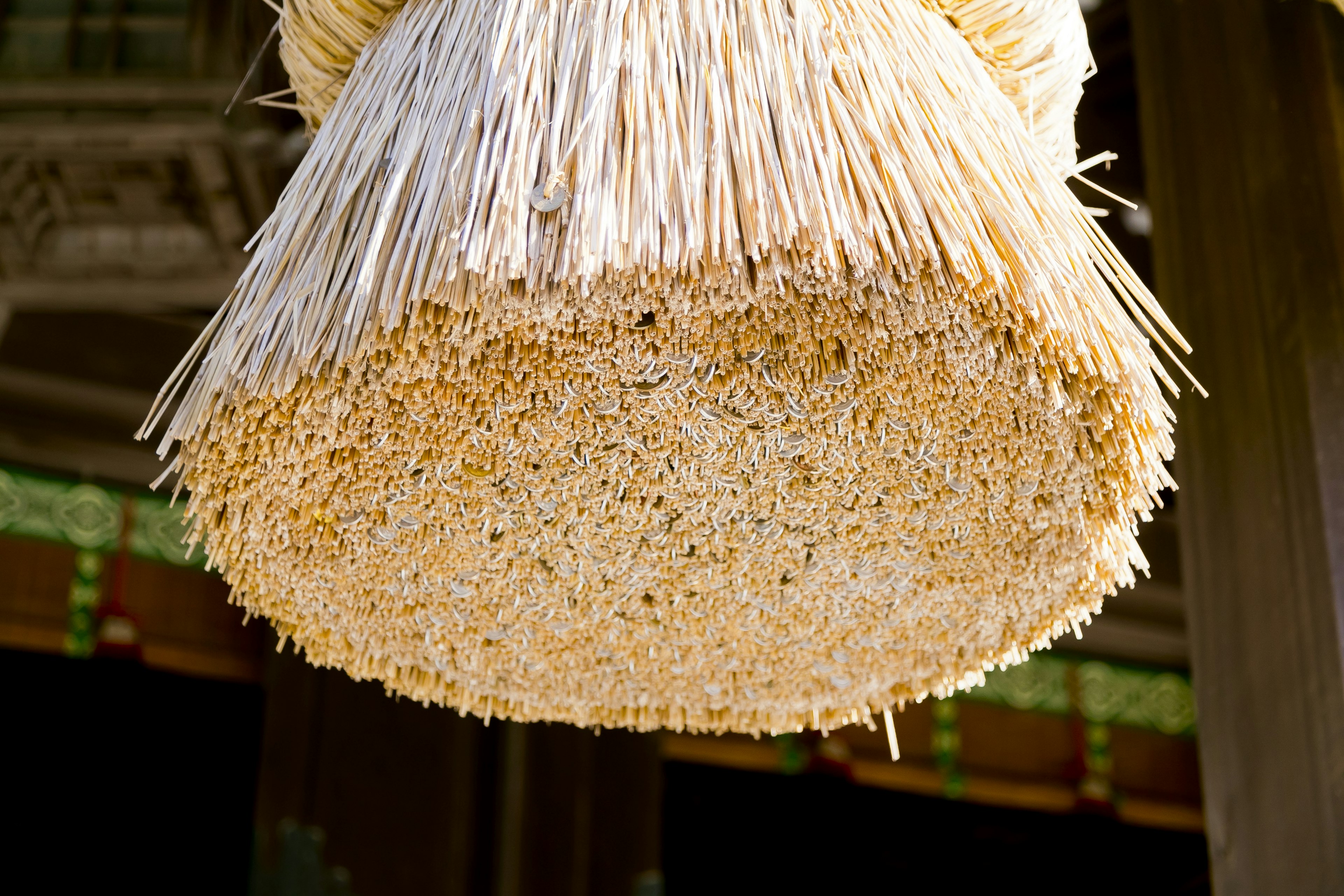 Round straw decoration hanging in a traditional setting