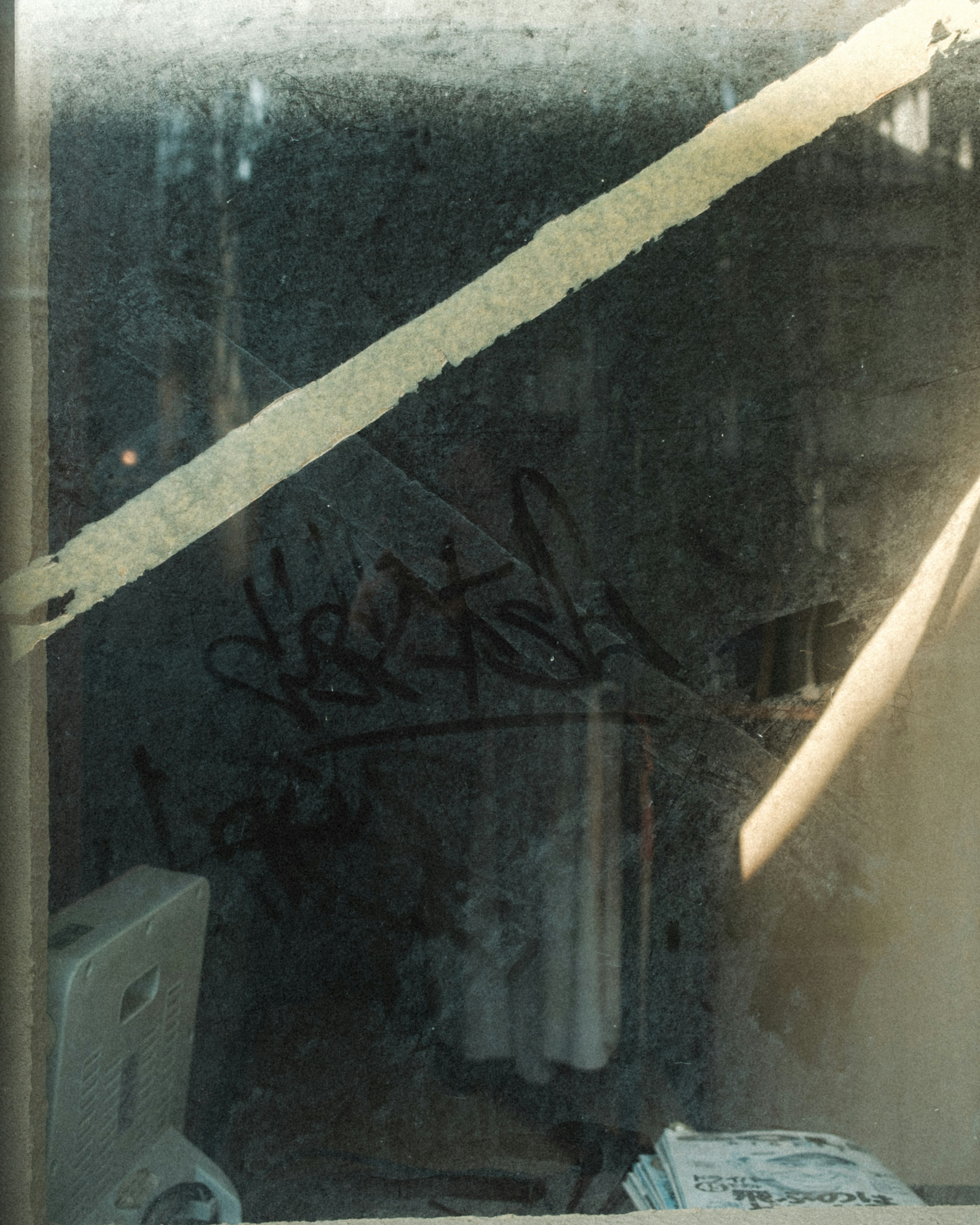 A view of a room through a foggy window with graffiti visible