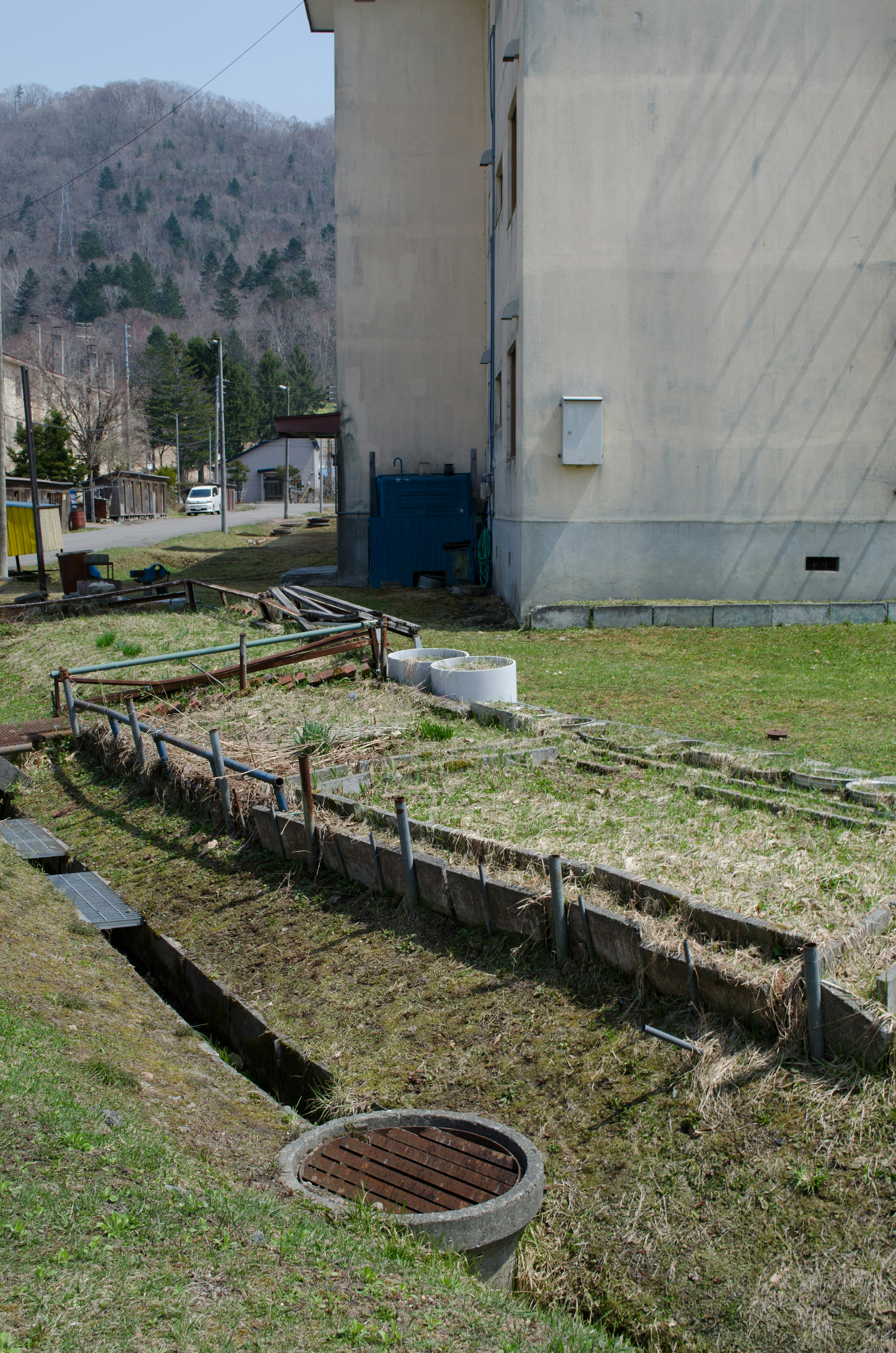 Drainage system along the side of a building with green grass