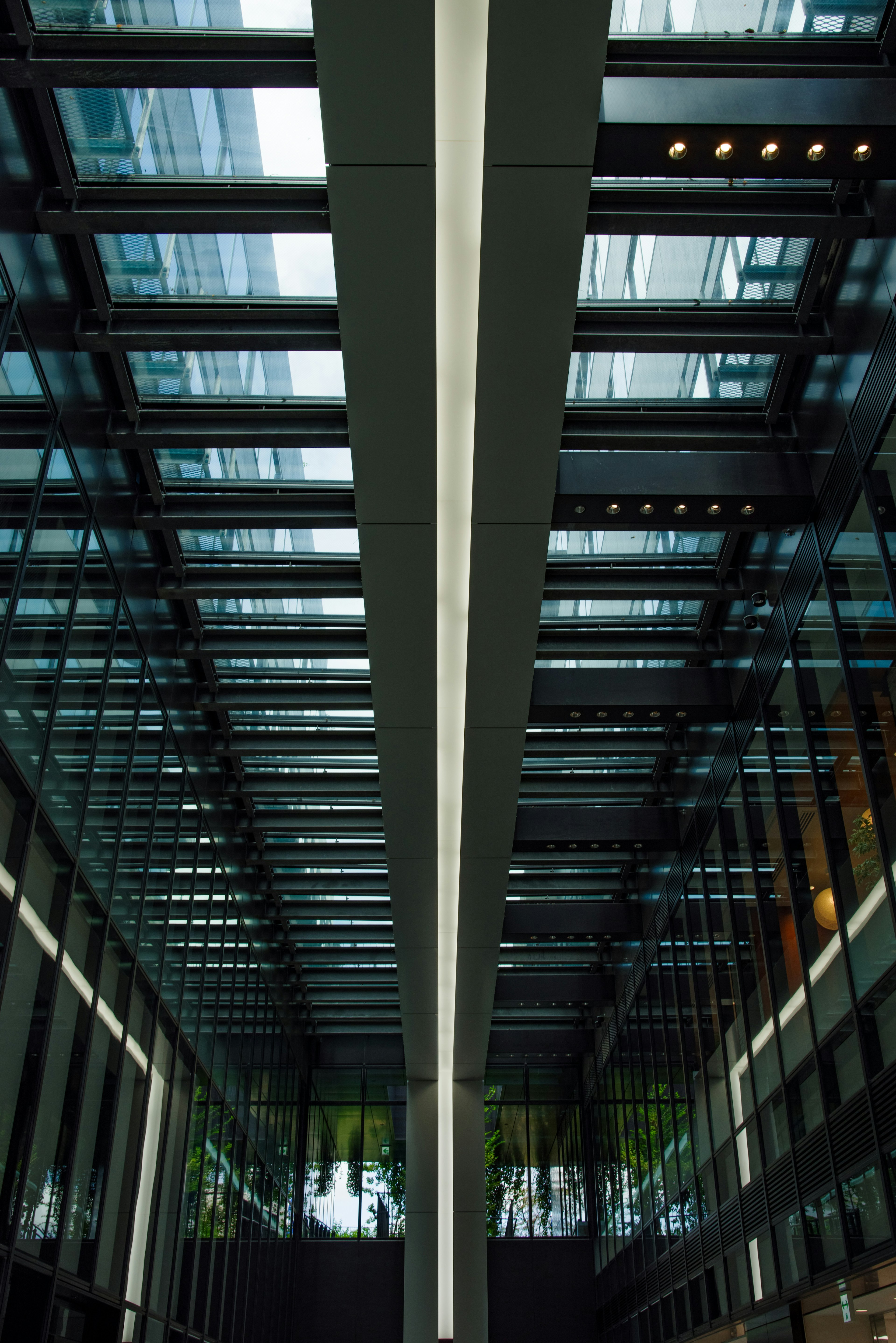 Interior of a modern building featuring a glass ceiling and linear design