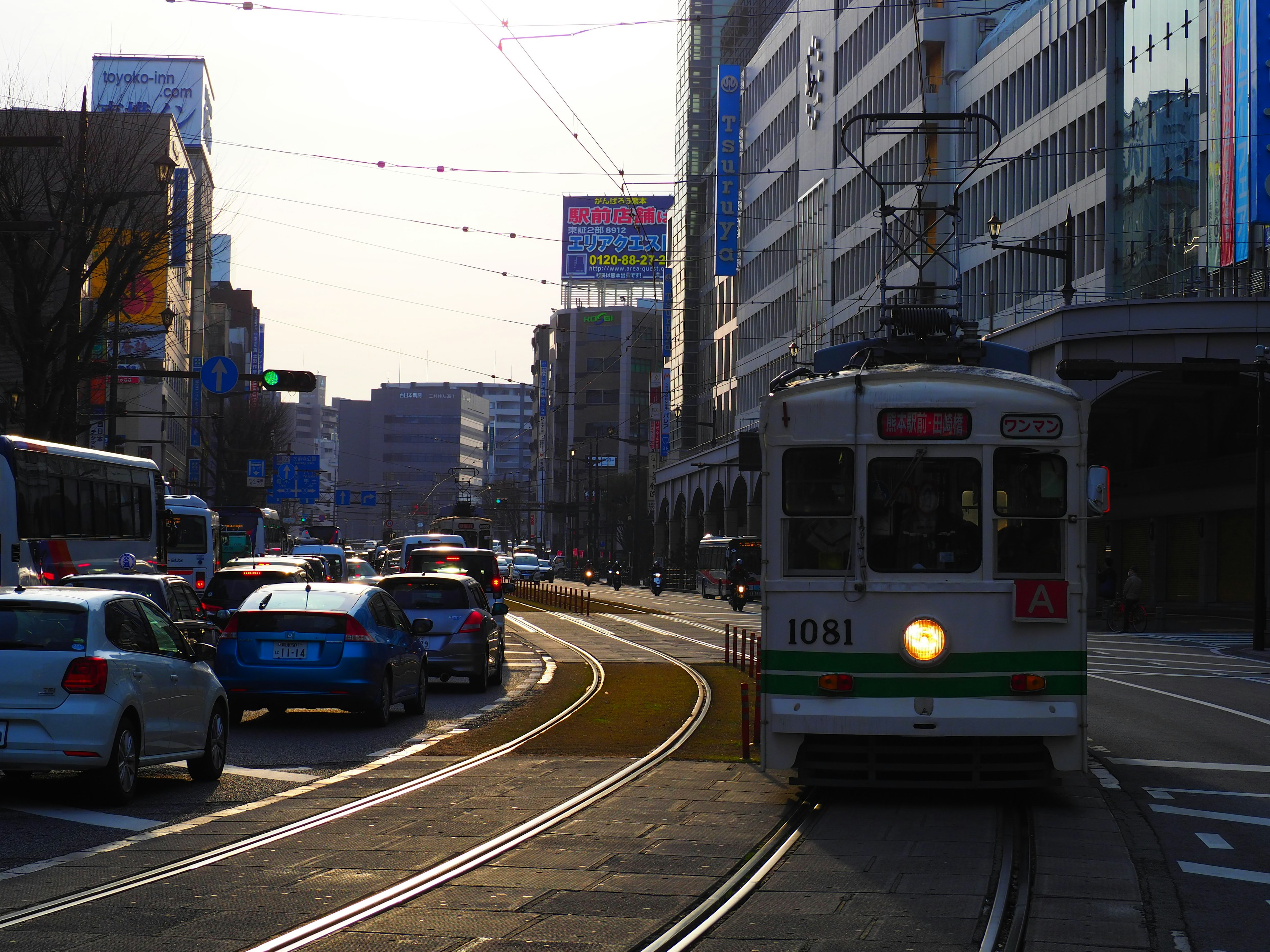 街道場景，路面電車與汽車在現代建築前