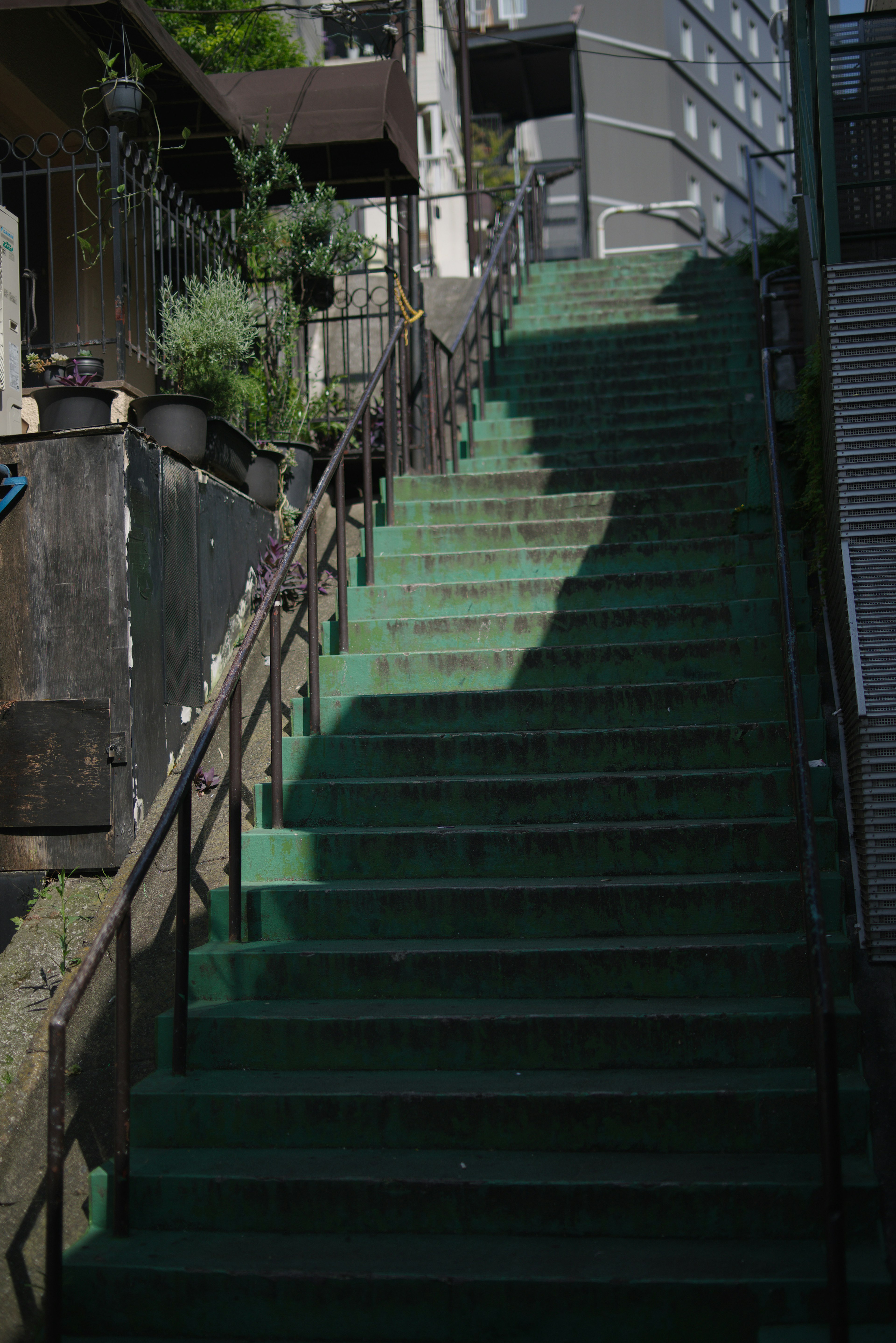 Residential area featuring green stairs with handrails