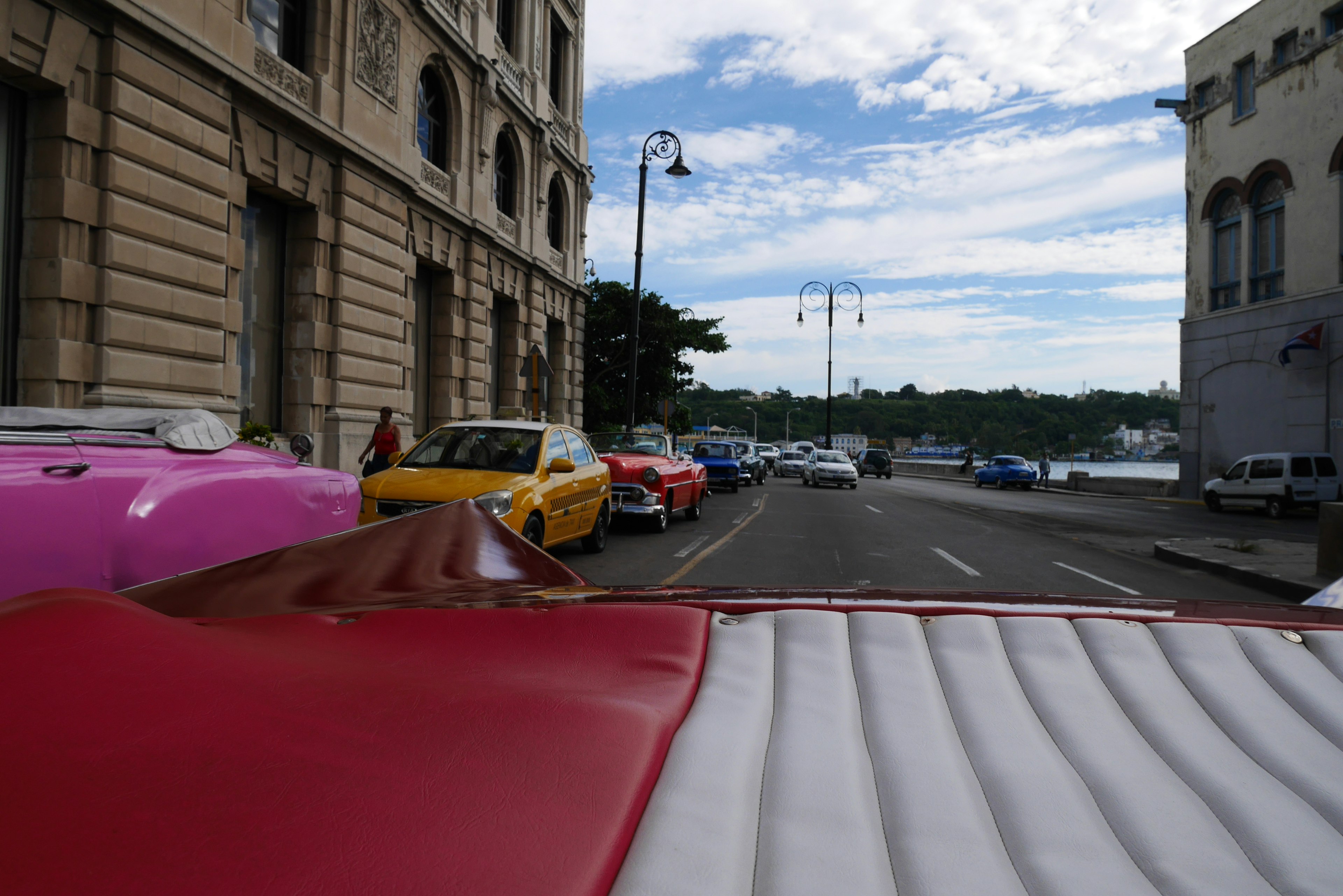 Colorful vintage cars lined up on a street