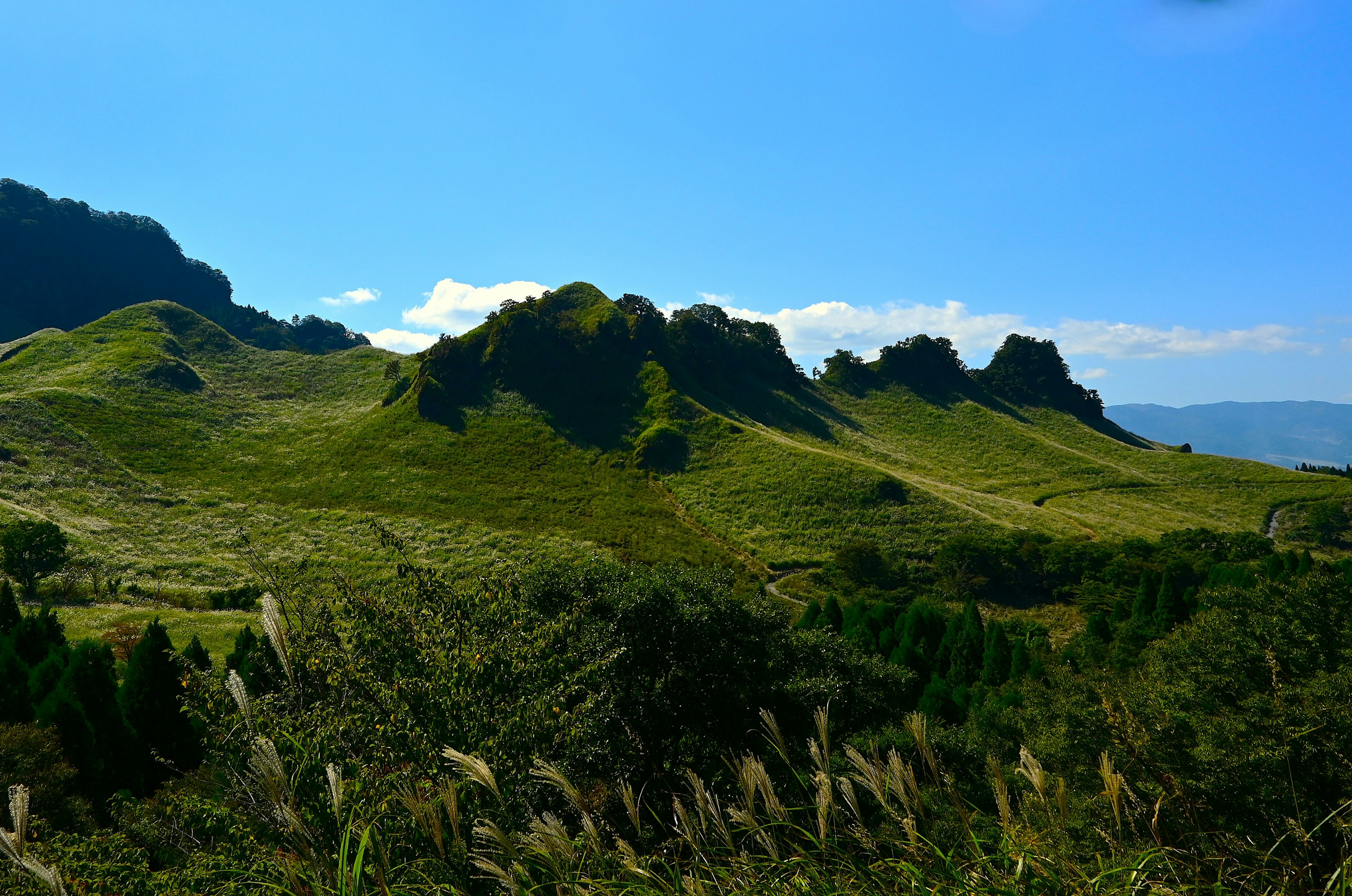 Lush green hills under a clear blue sky