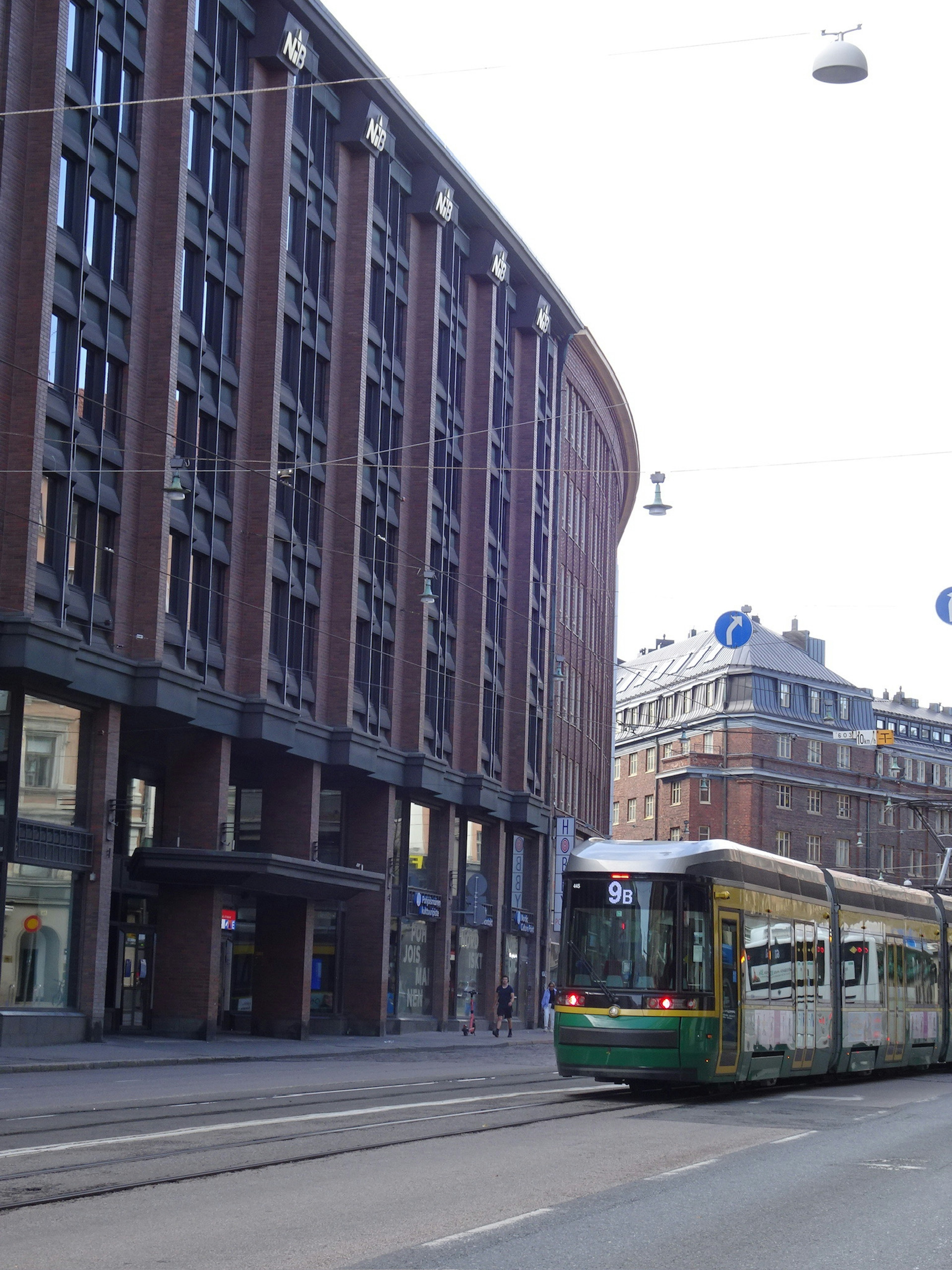 Tram on the street with modern architecture in view