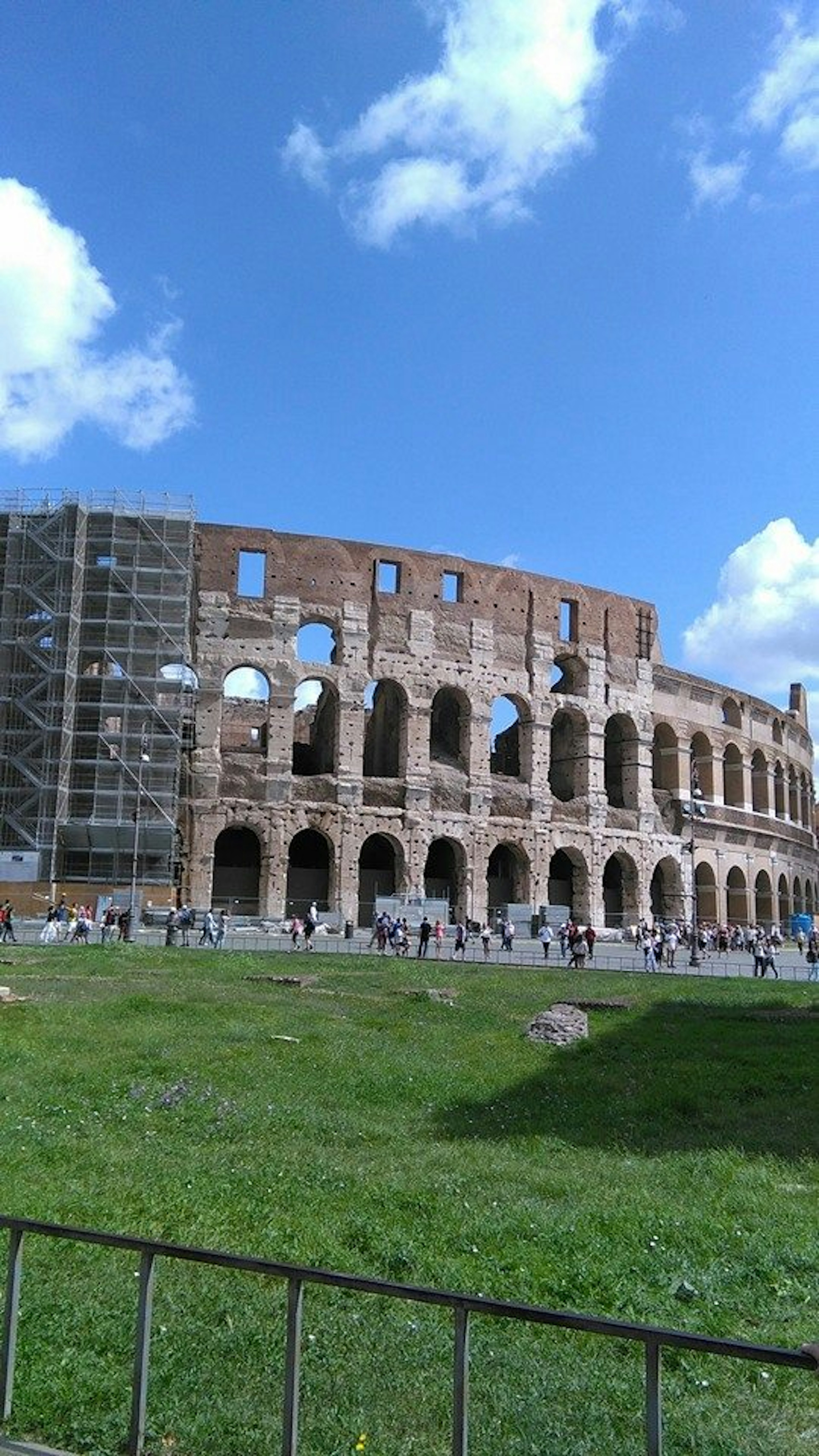 Exterior view of the Colosseum in Rome with blue sky