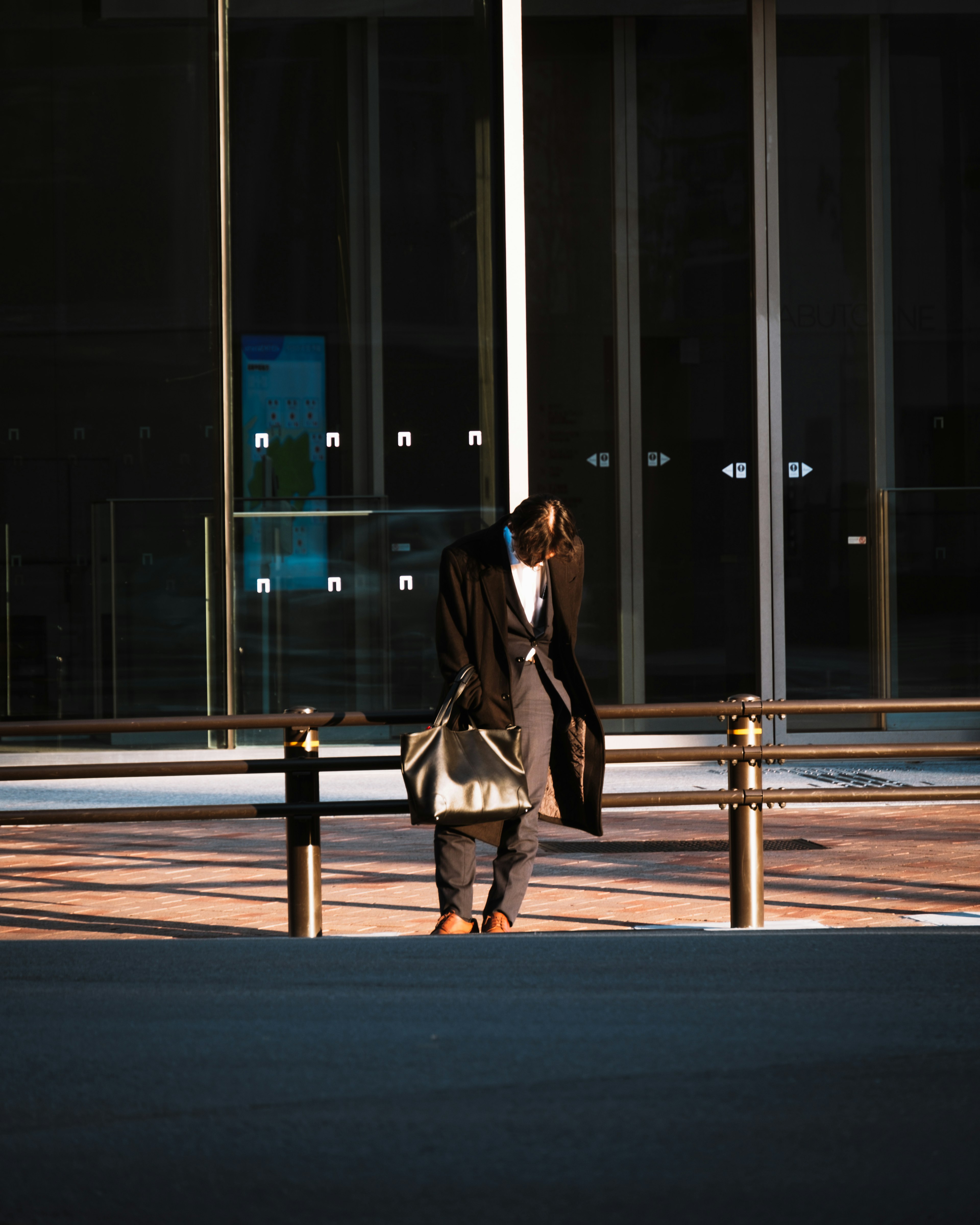 Silhouette of a person standing against a dark background