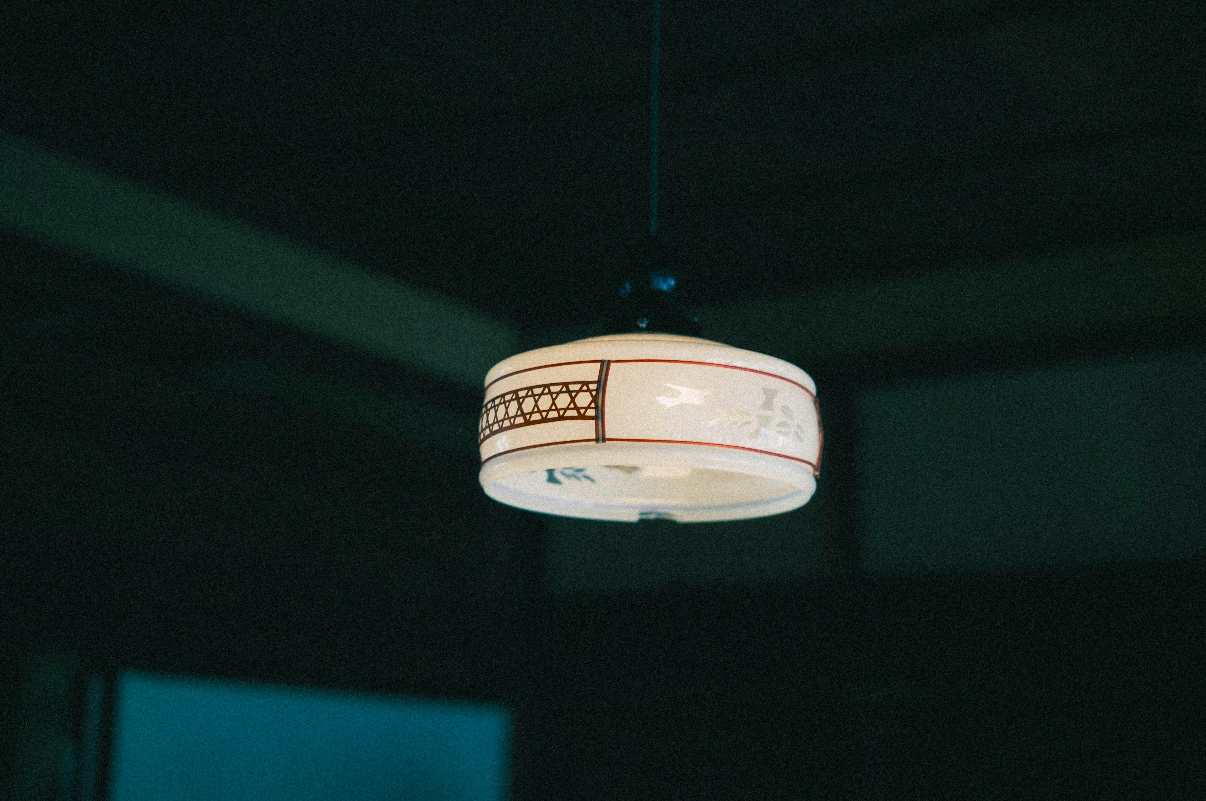 Decorative white ceiling light fixture hanging from the ceiling