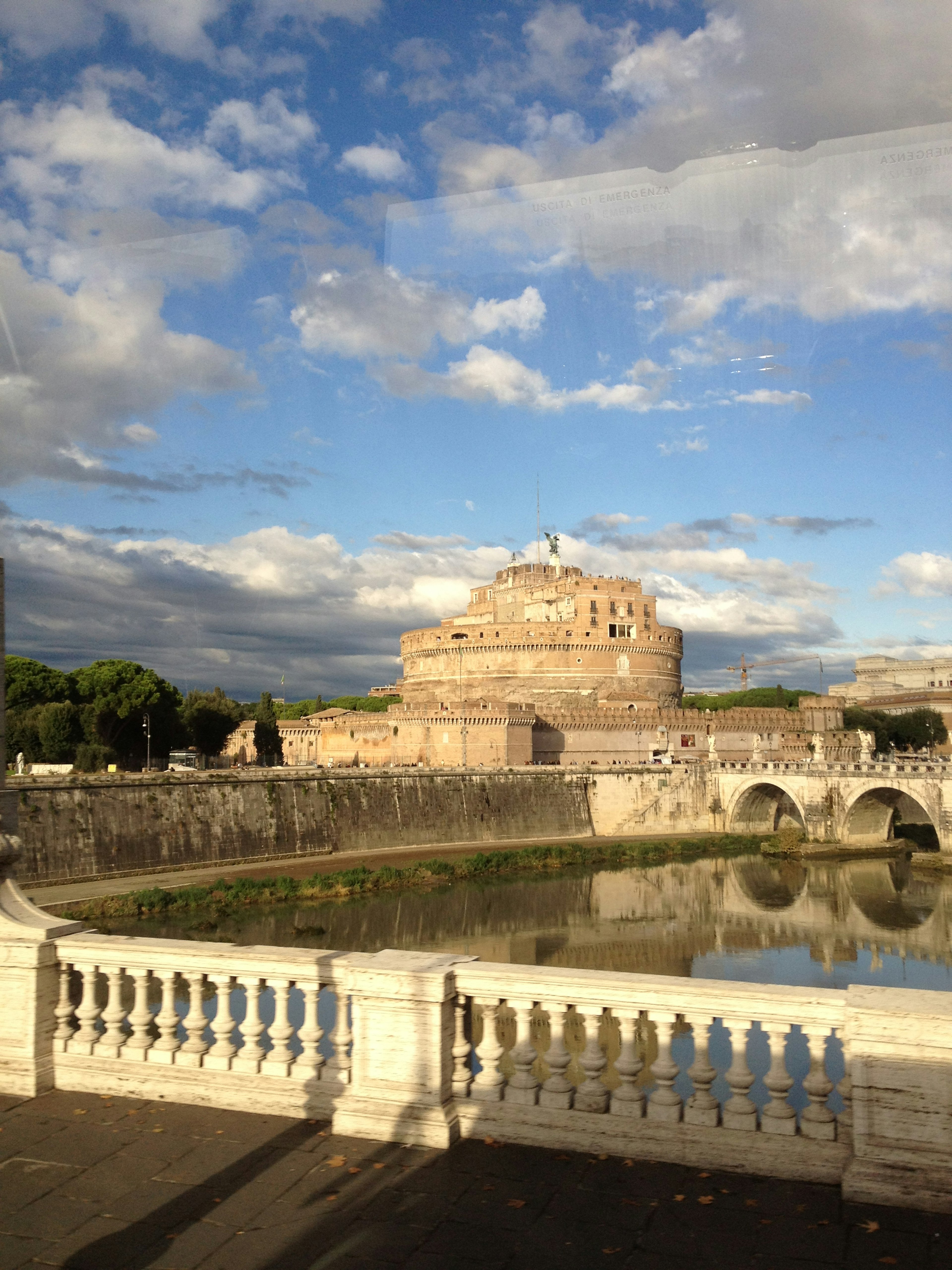 Beautiful riverside view with a historic building reflecting in the water near the Tiber River