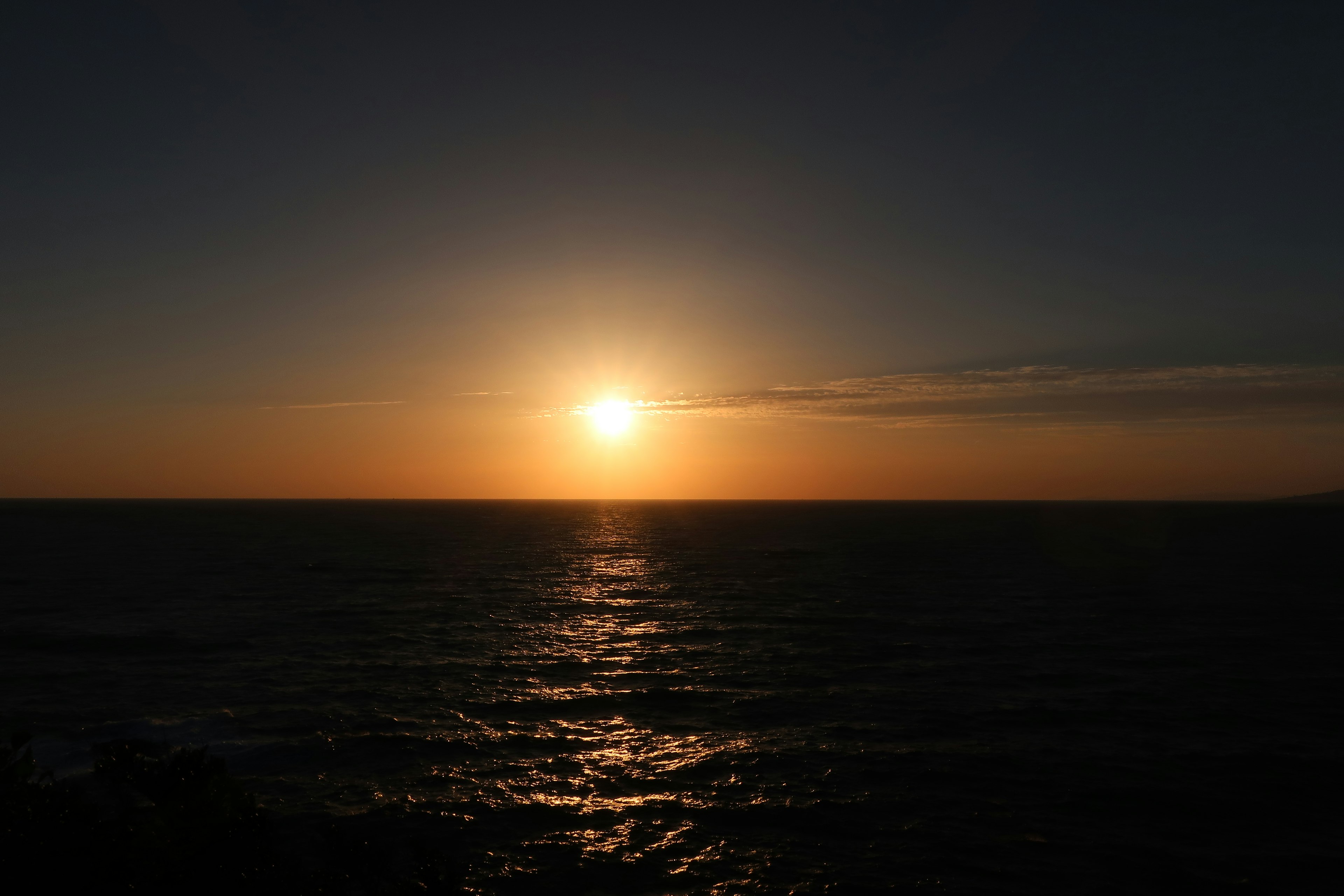 Sunset over the ocean with calm waves