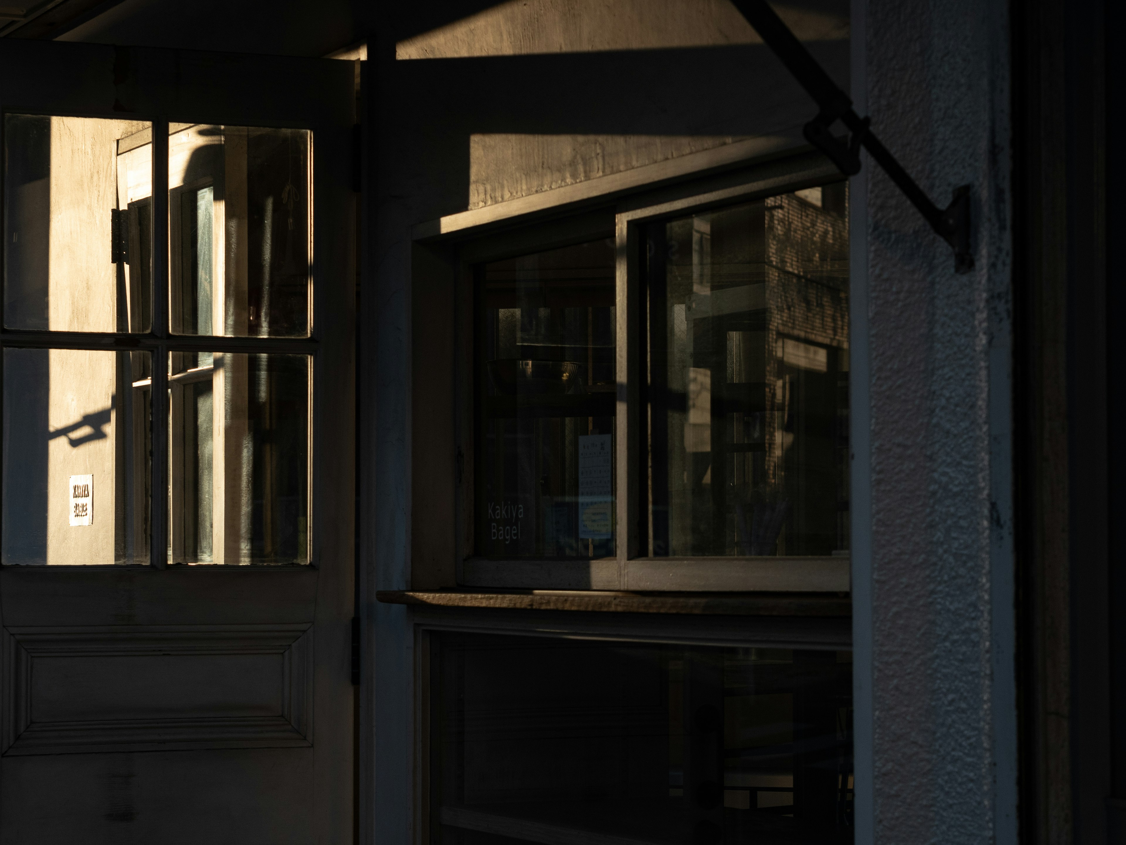 A quiet scene featuring a door and windows in a dark background