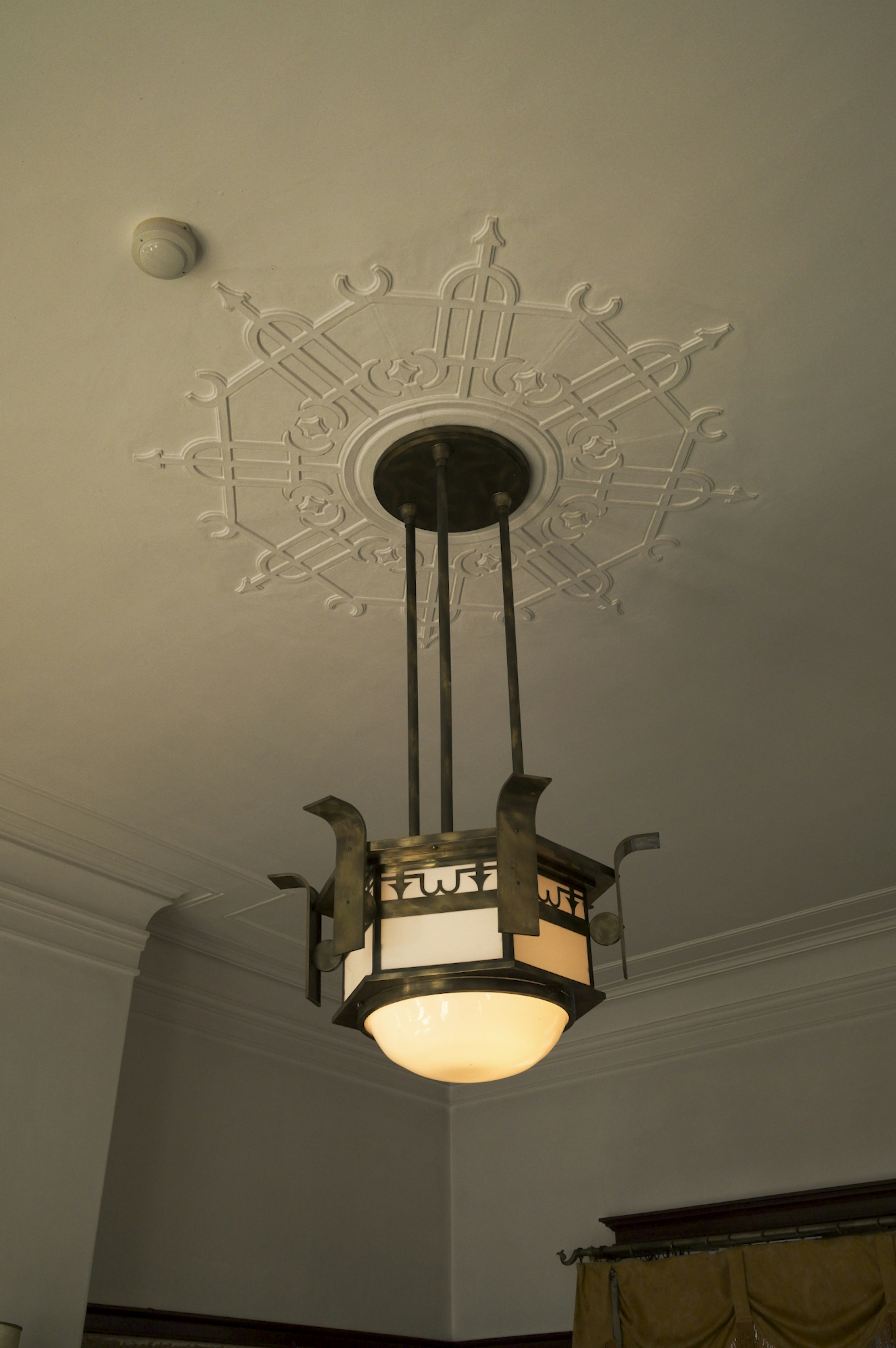 An ornate chandelier hanging from the ceiling with intricate details