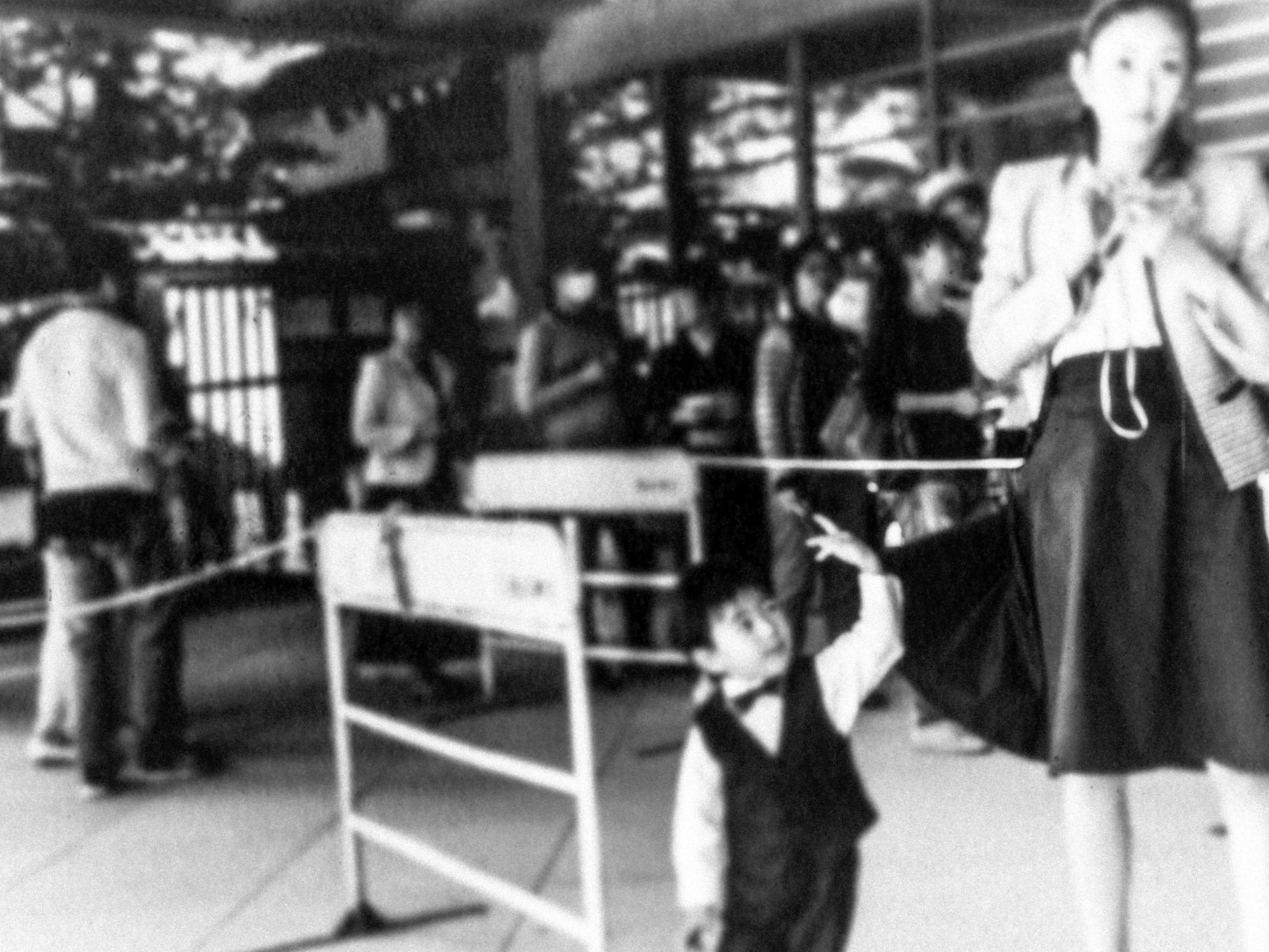 Black and white photo of an adult woman and a small boy in a crowded area