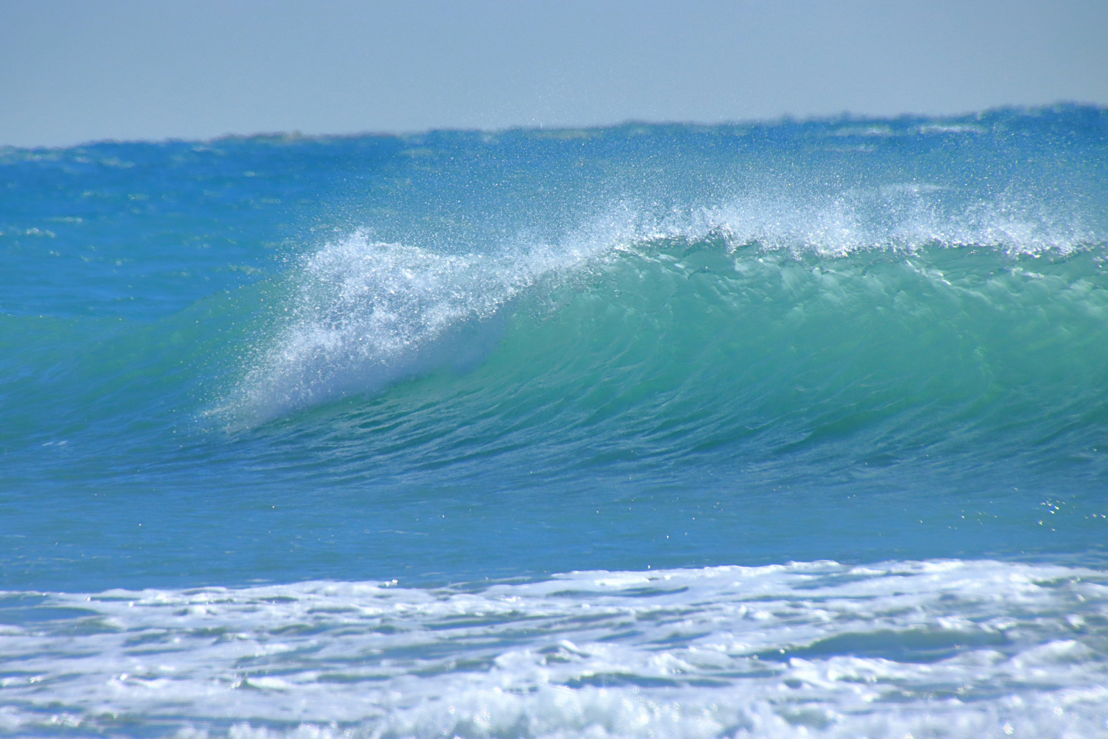 Gentle blue ocean waves rolling onto the shore