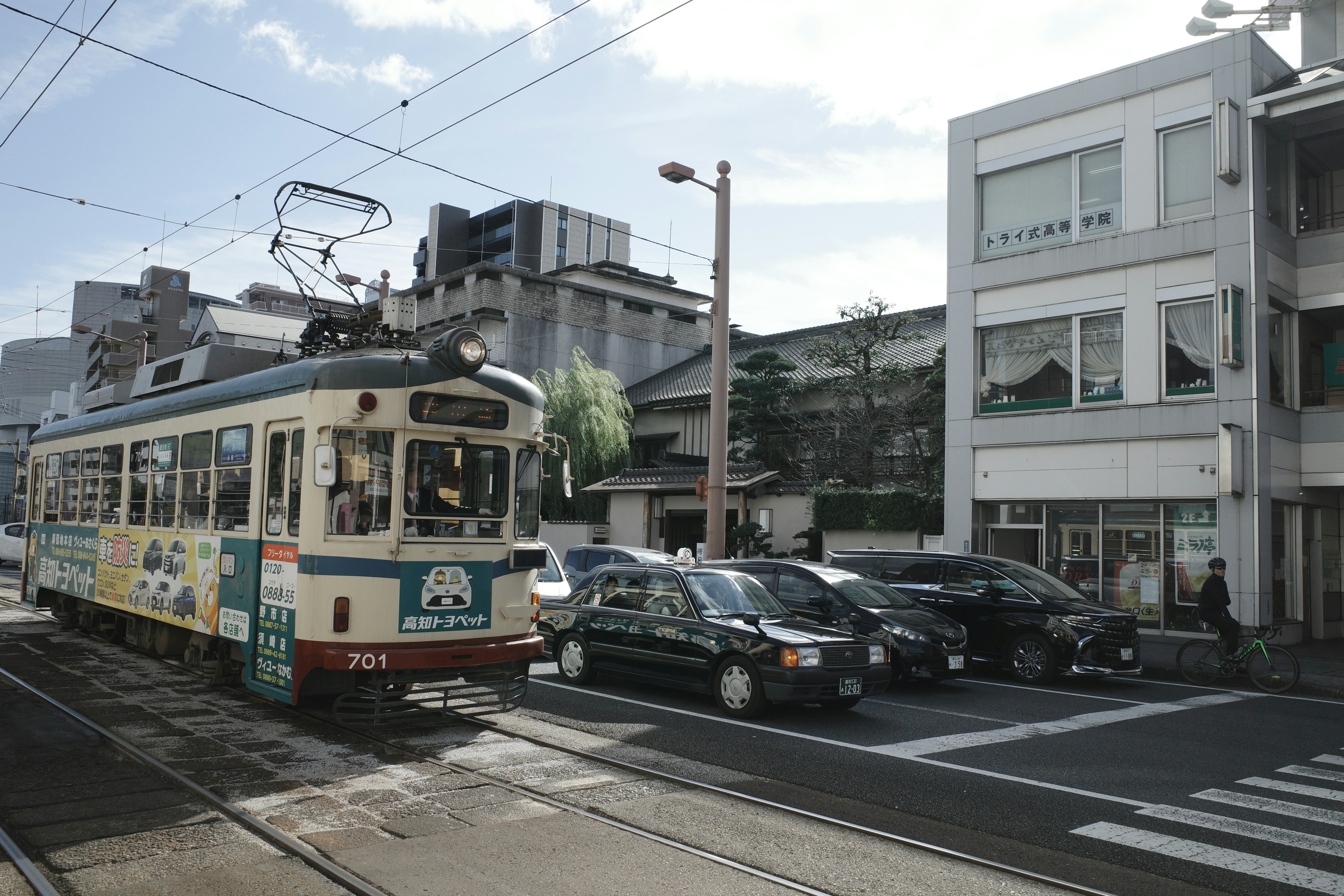 トラムが通る街の風景と車が並ぶ交差点の様子