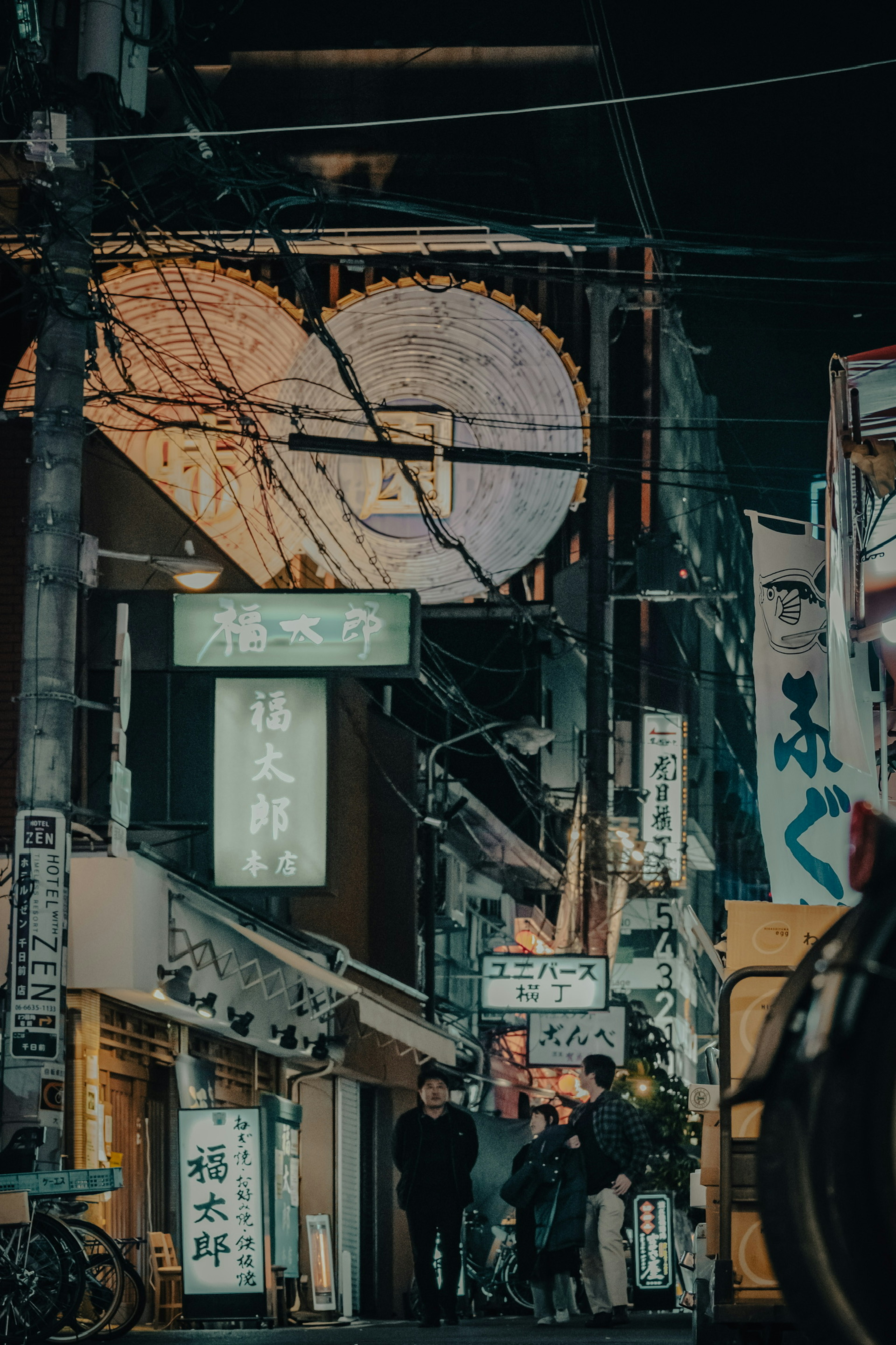 Nighttime street view with shops and lanterns