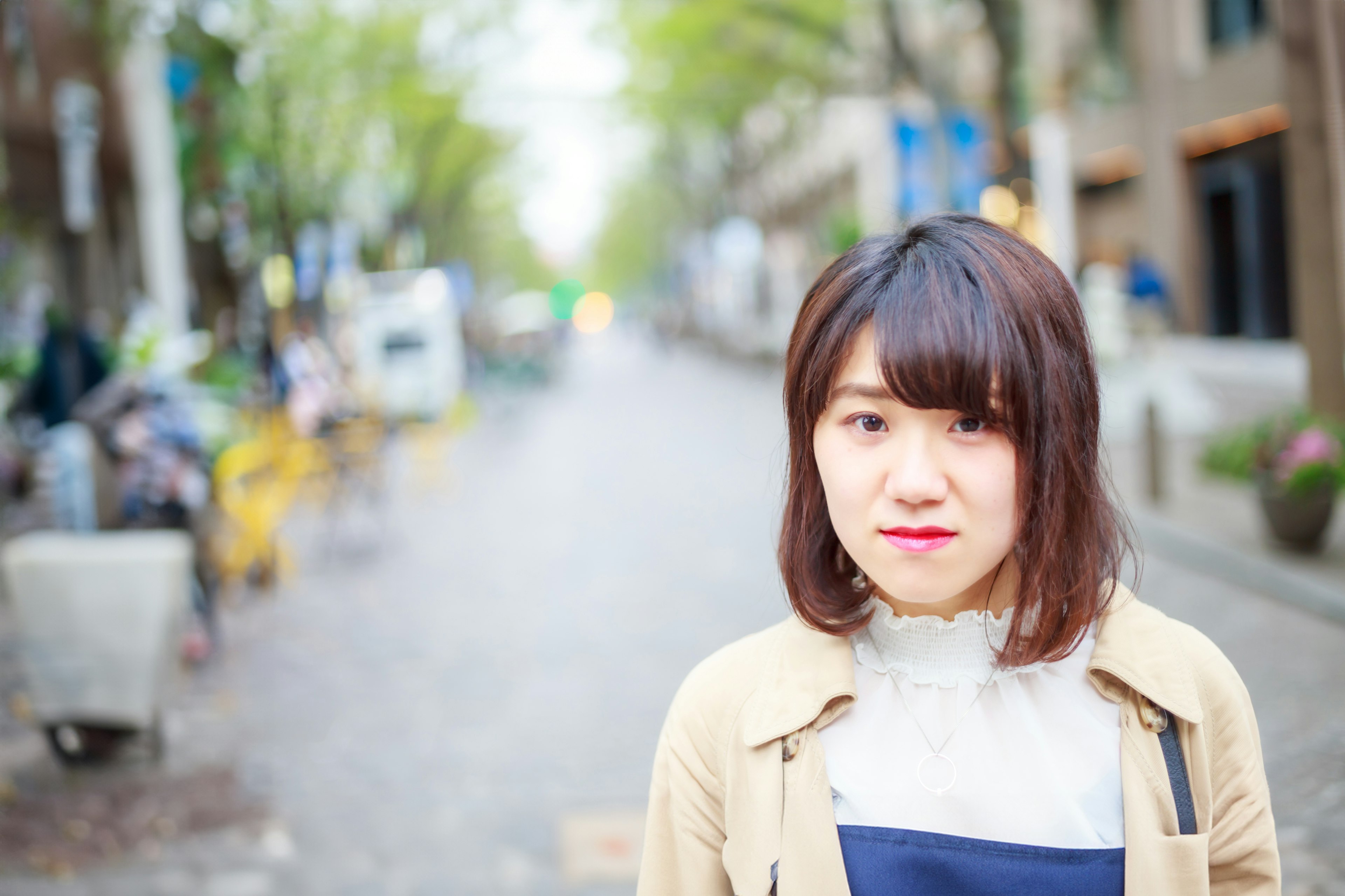 Portrait of a young woman smiling in the street