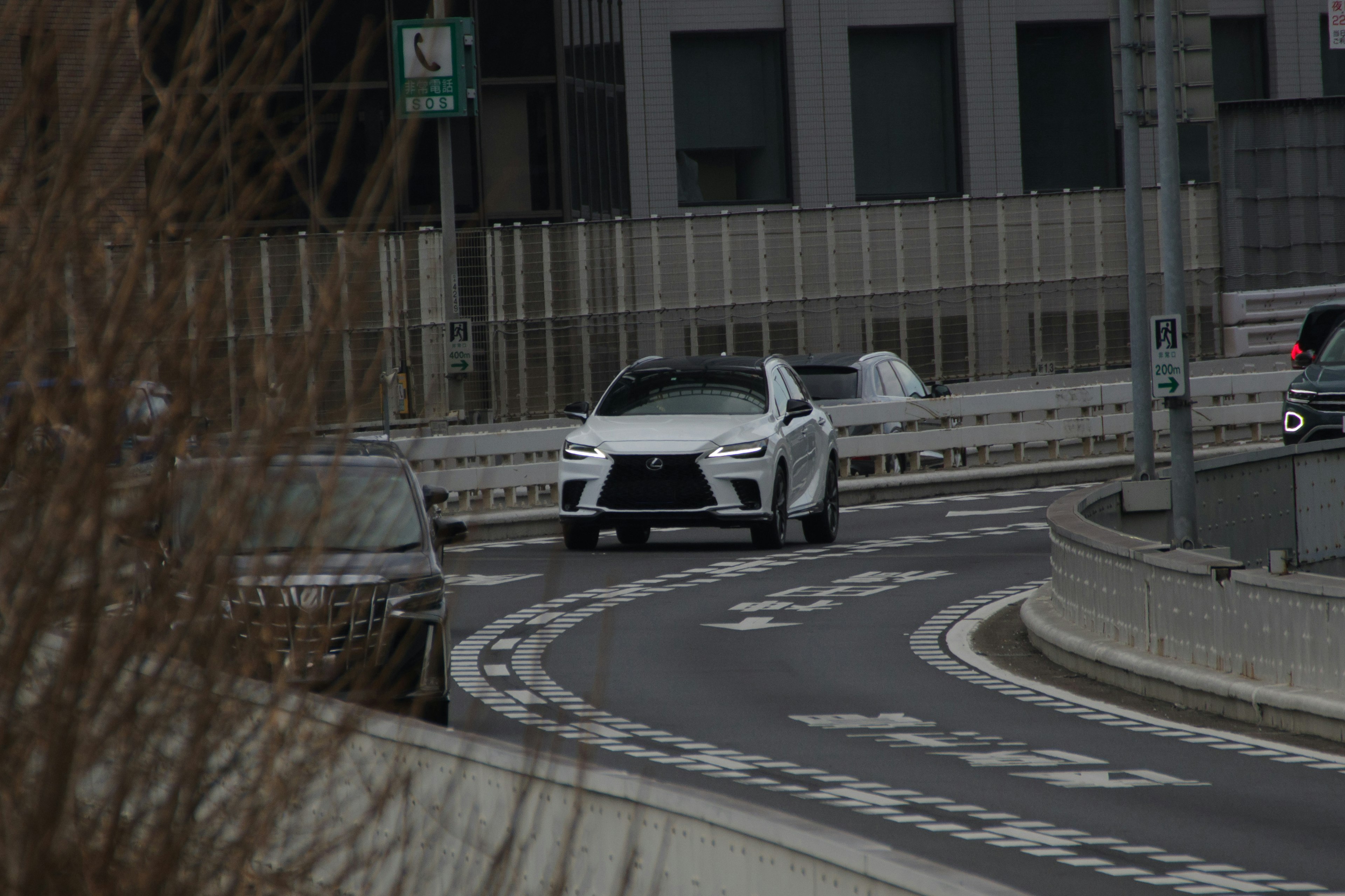 White SUV navigating a curved city road