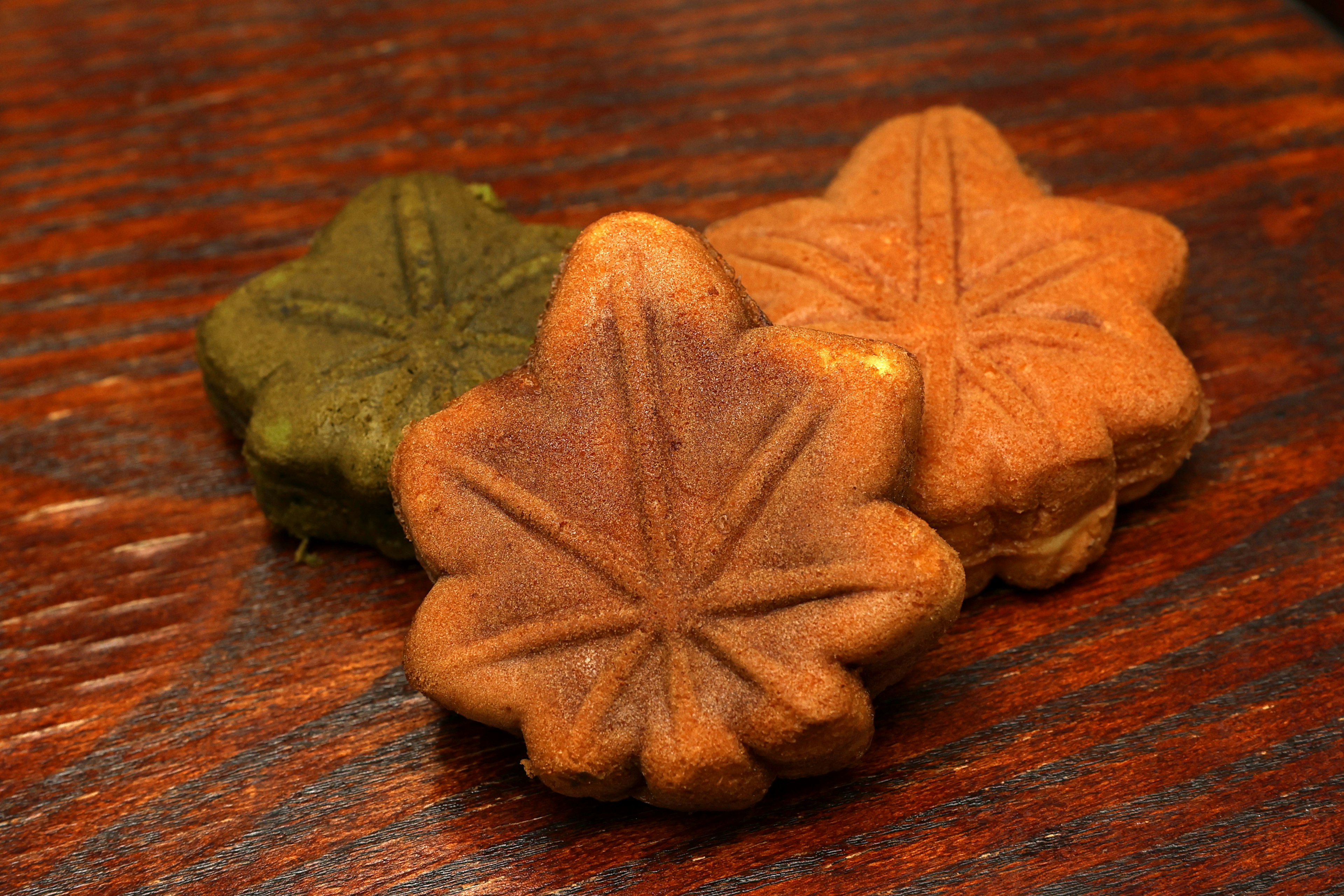 Colorful leaf-shaped sweets arranged on a wooden table