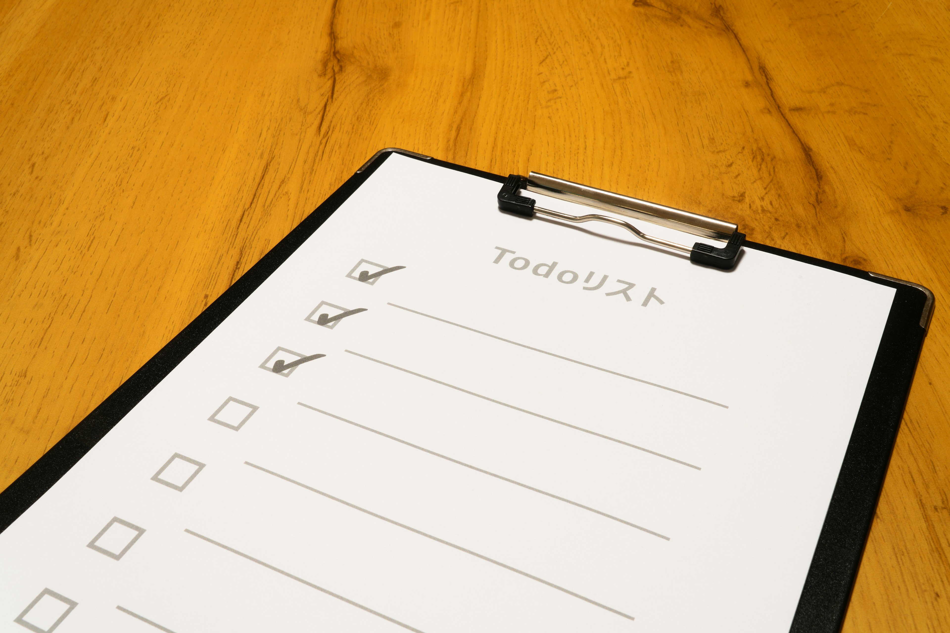 Clipboard with a checklist on a wooden table