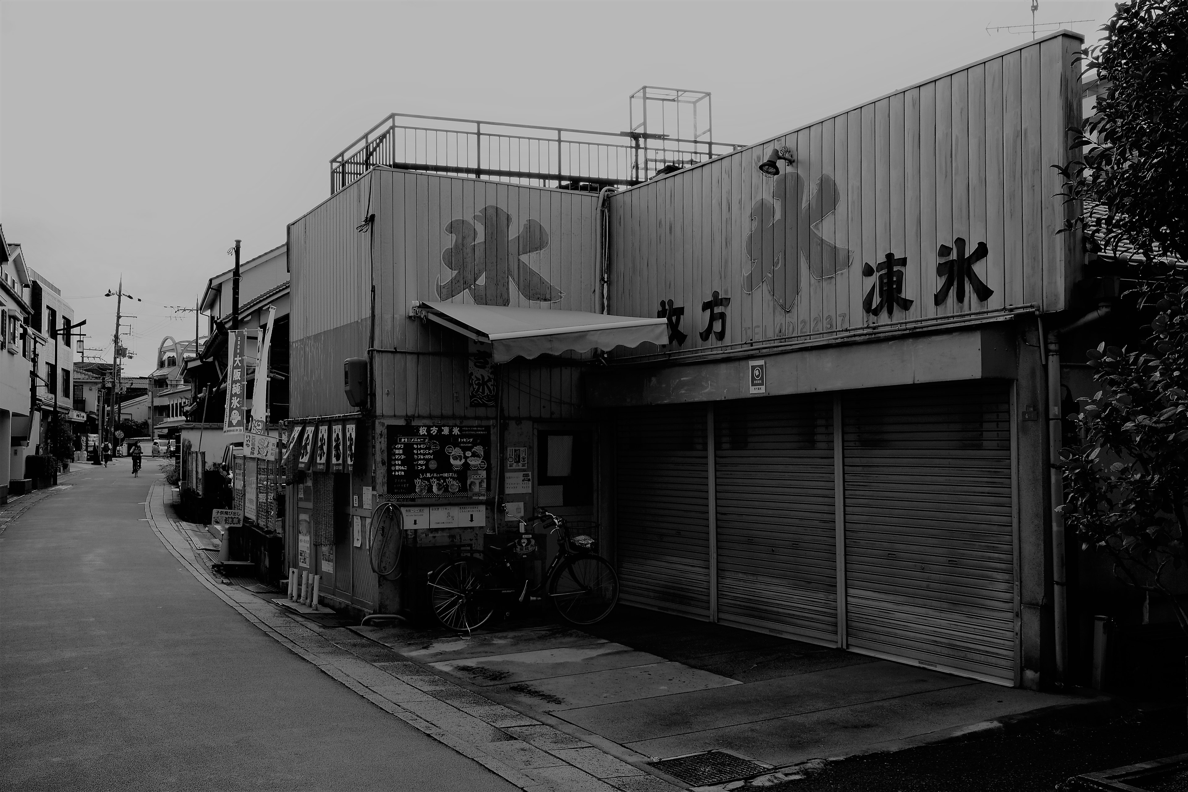 Monochrome photo of an old ice shop exterior