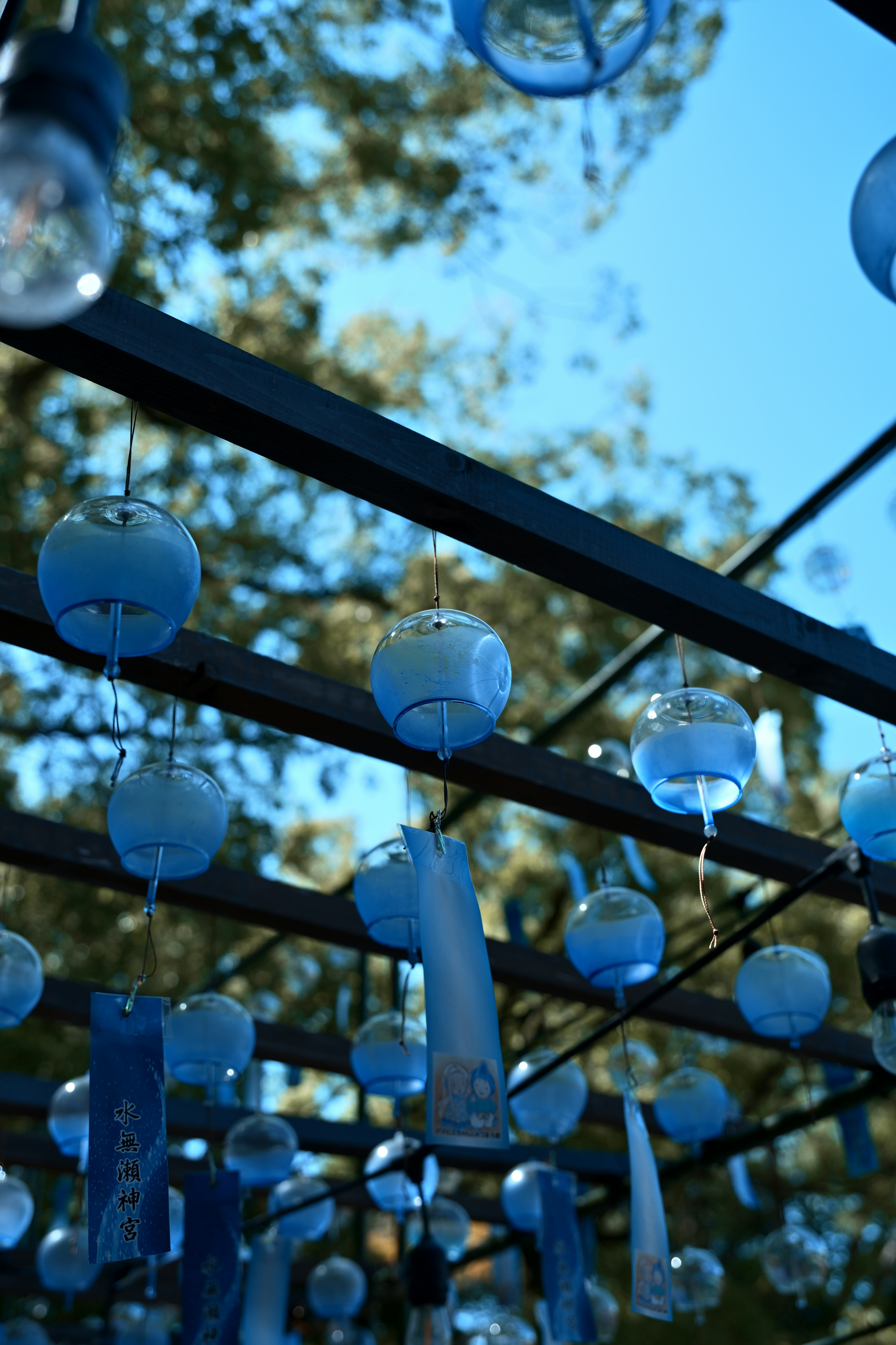 Outdoor space with hanging blue wind chimes