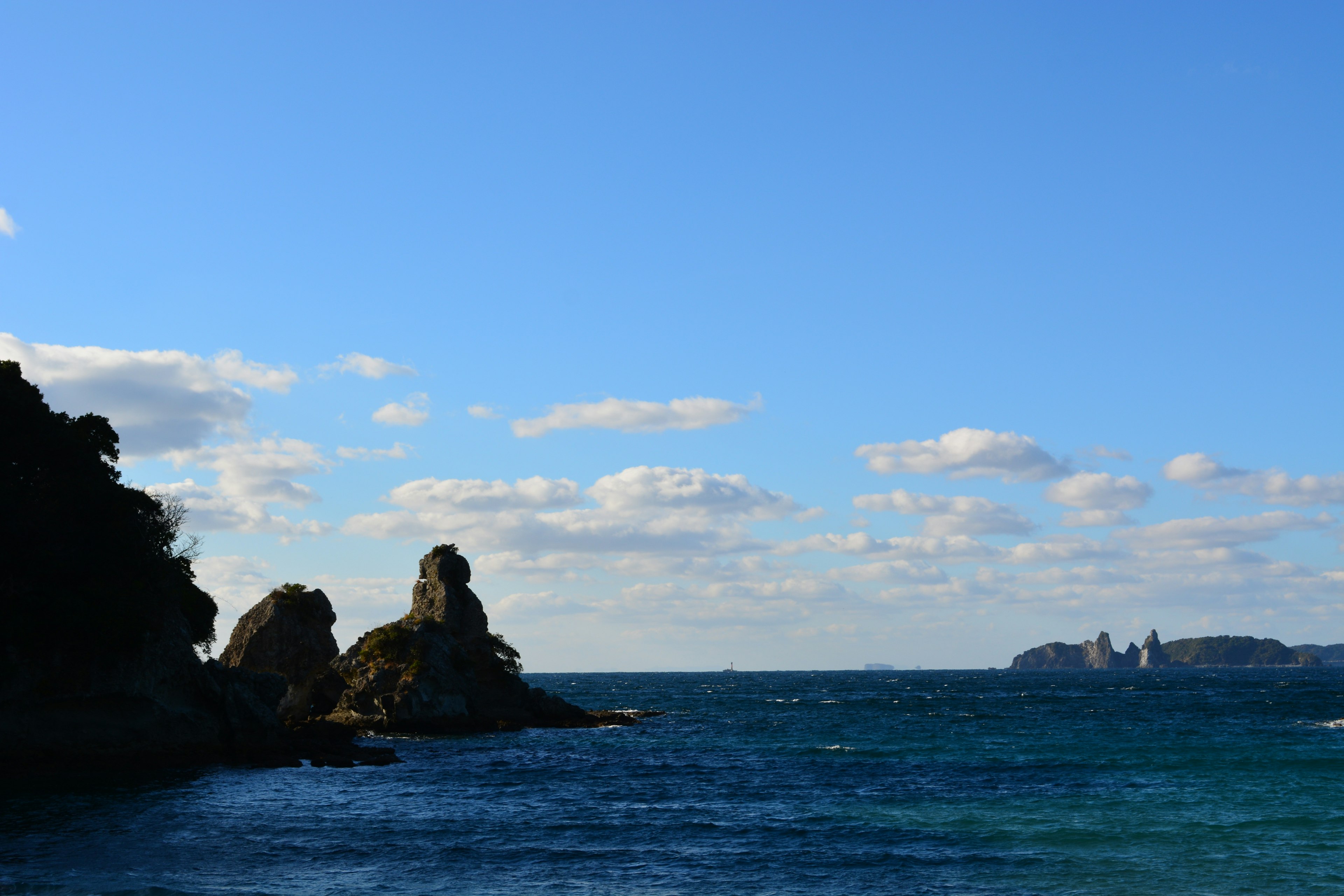 青い海と空の下に岩がある風景