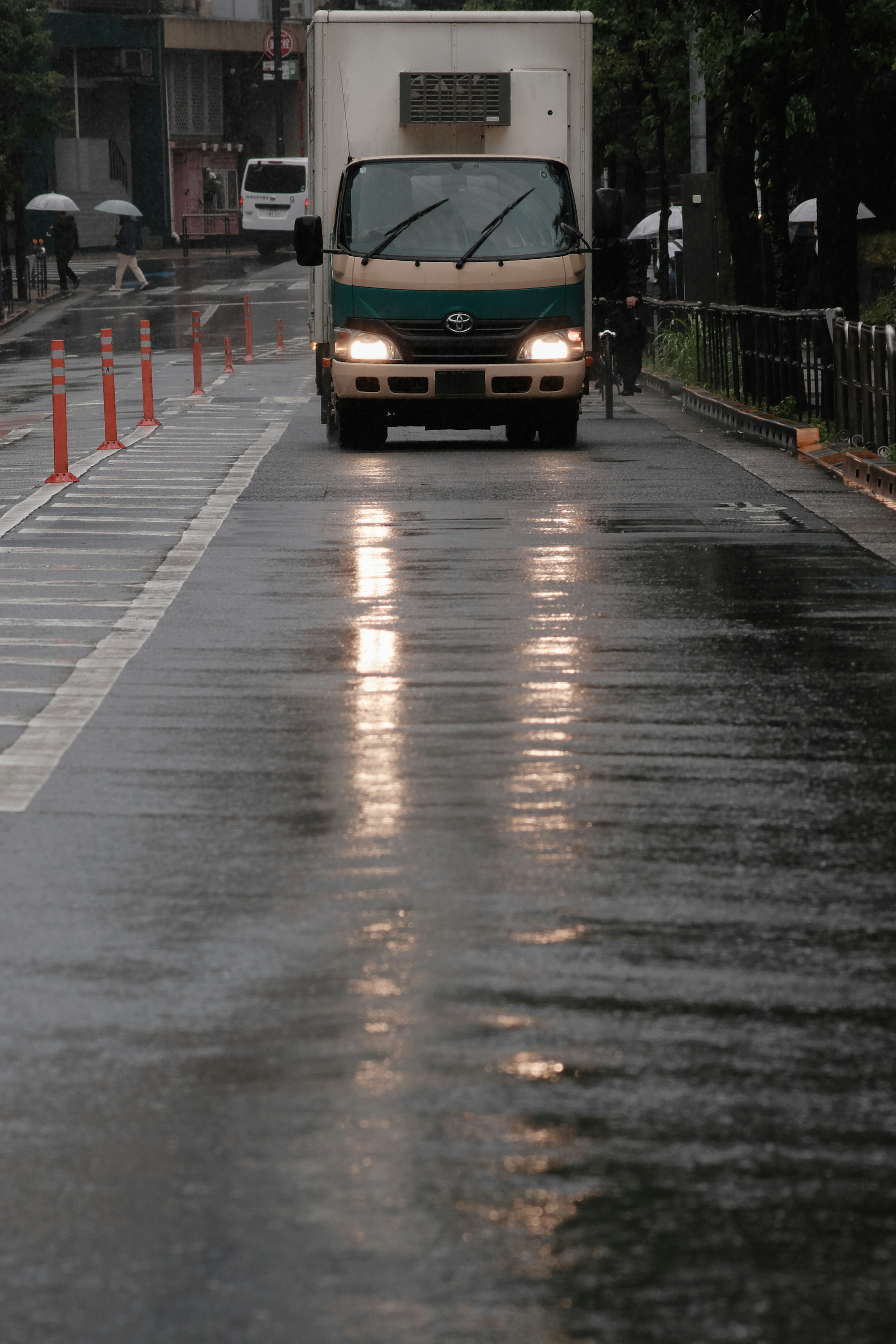 Truck driving on a wet road during rain with reflections