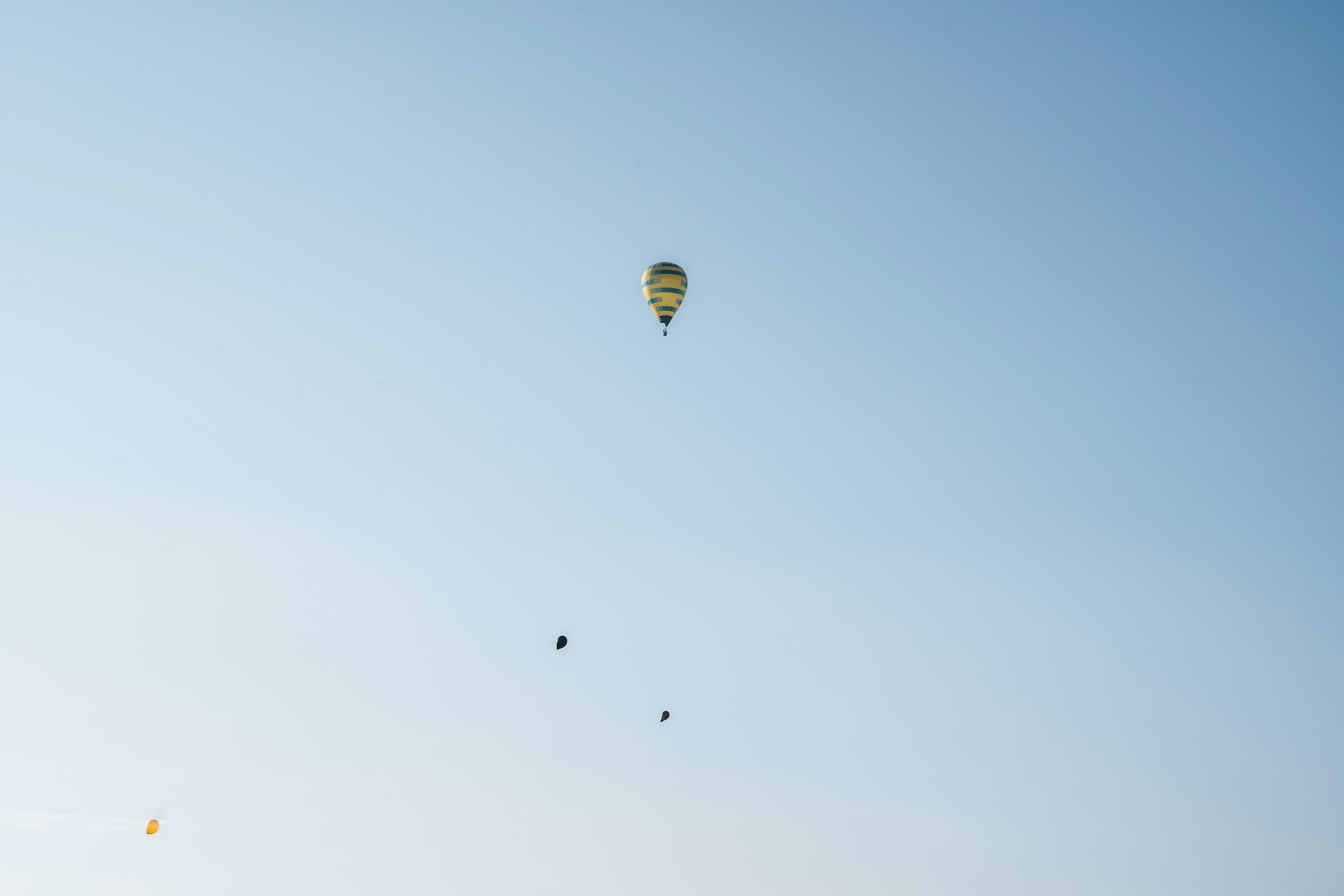 Hot air balloons floating in a clear blue sky