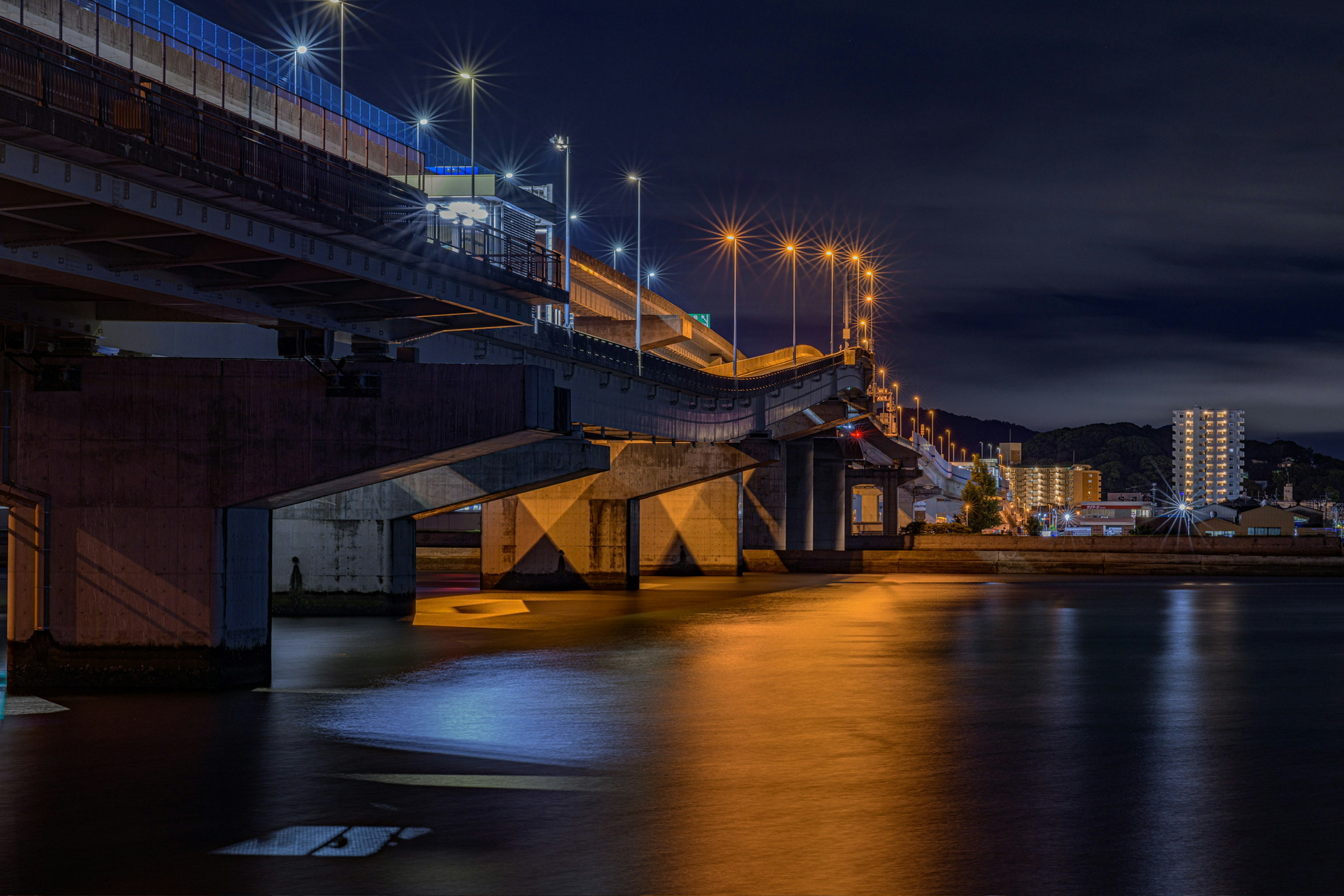 Night view of a bridge with reflections on the water