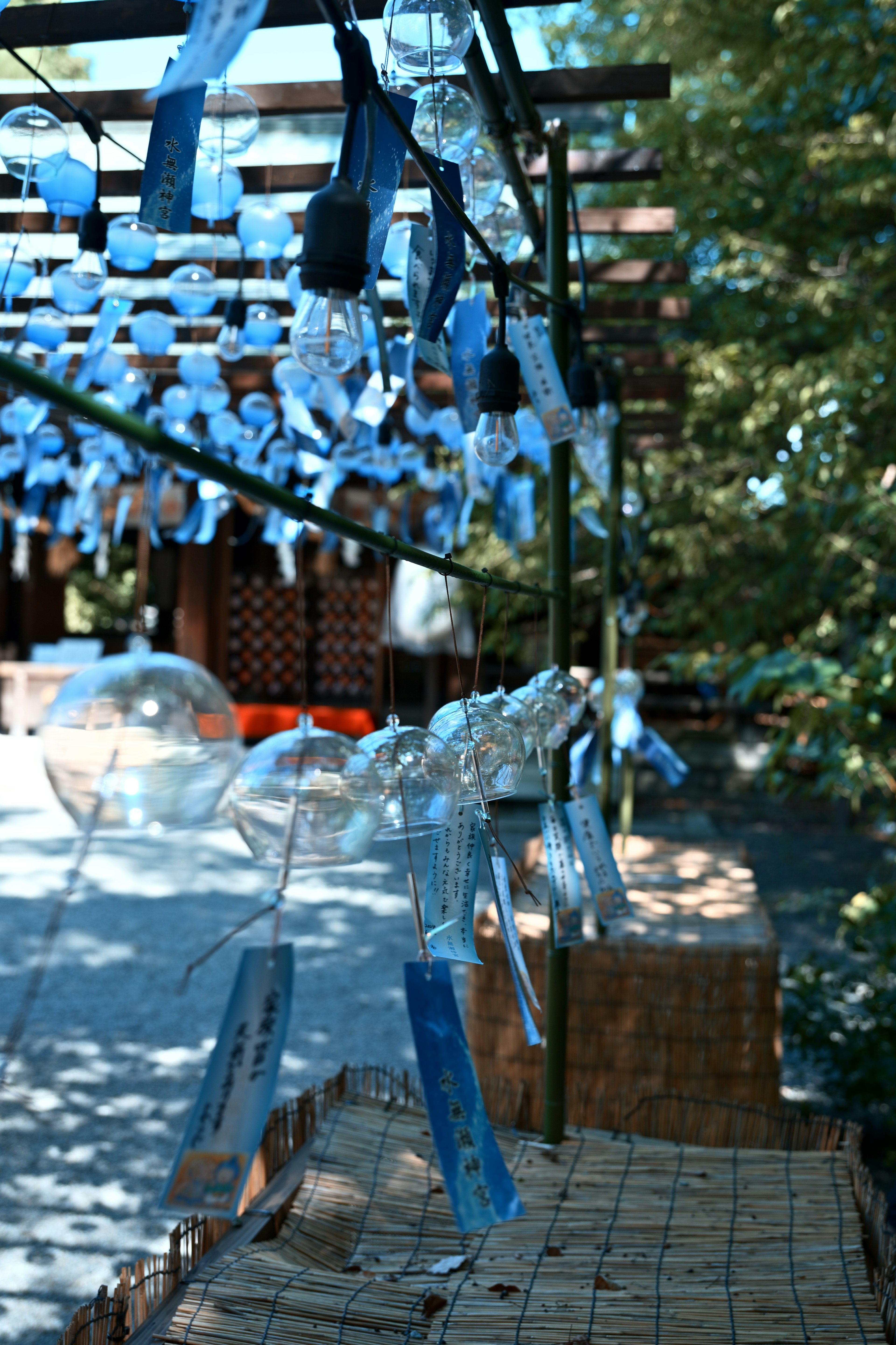 A scene featuring blue wind chimes hanging from a structure