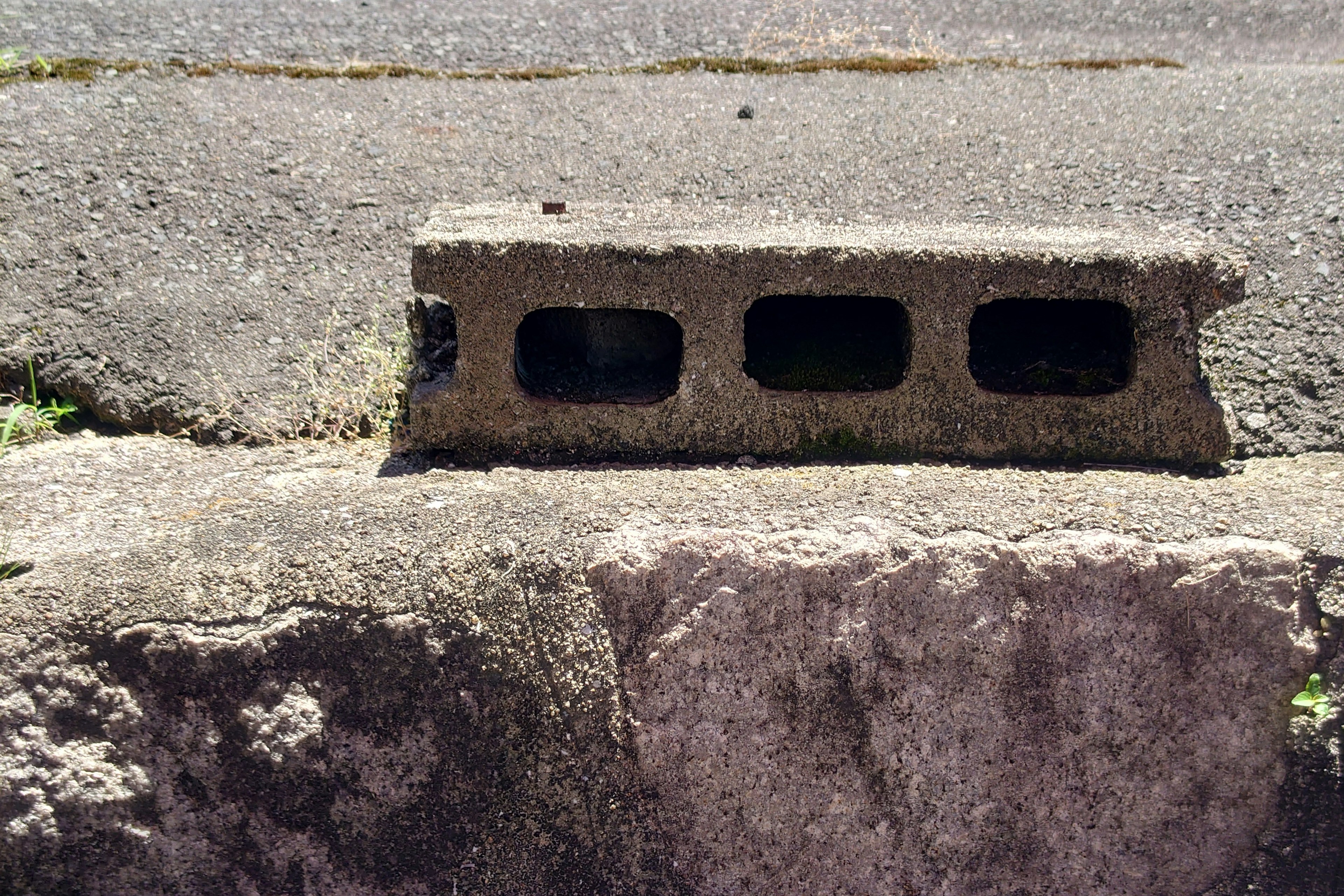 Close-up of a concrete block placed on pavement