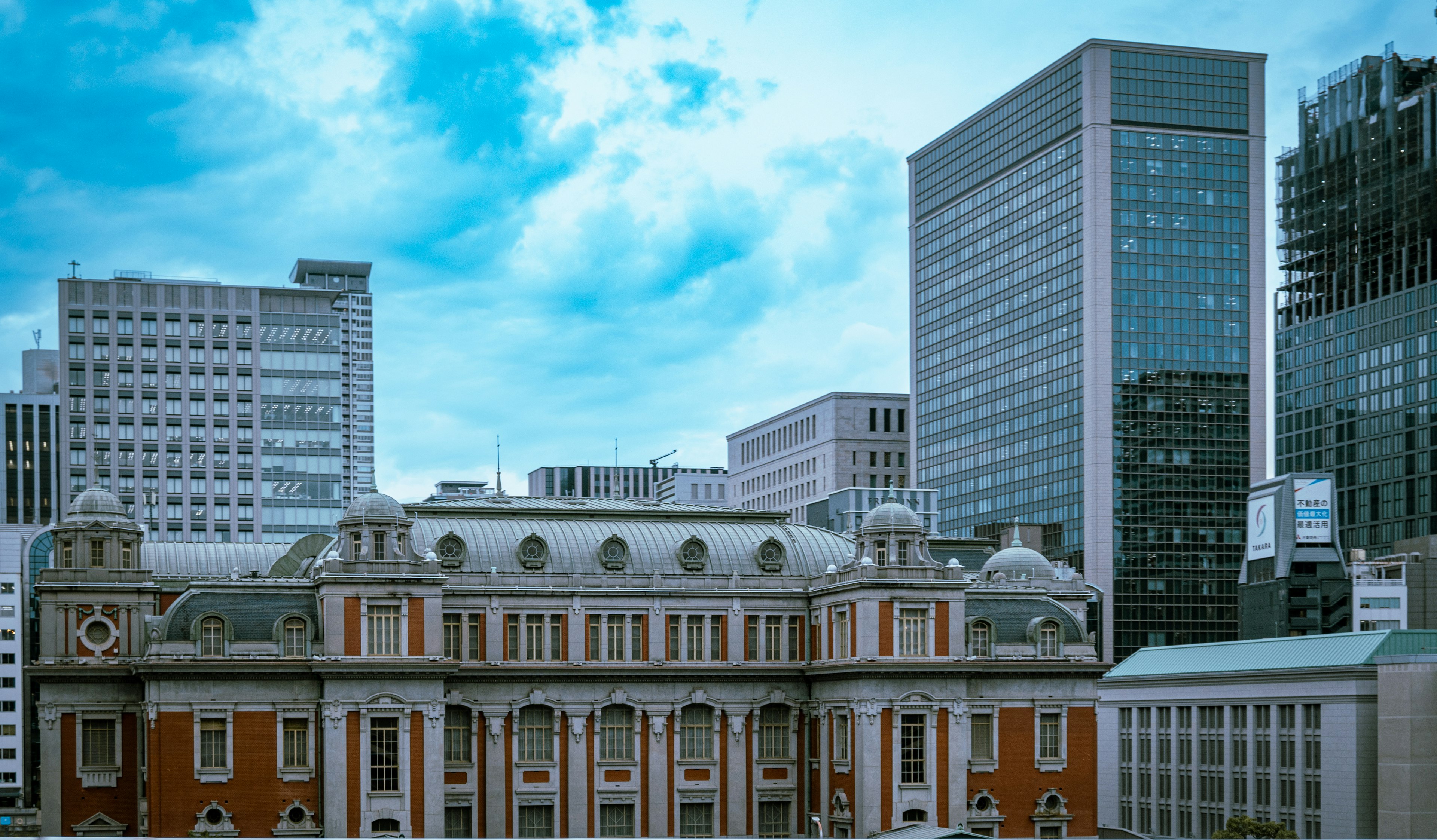 Historic building surrounded by modern skyscrapers