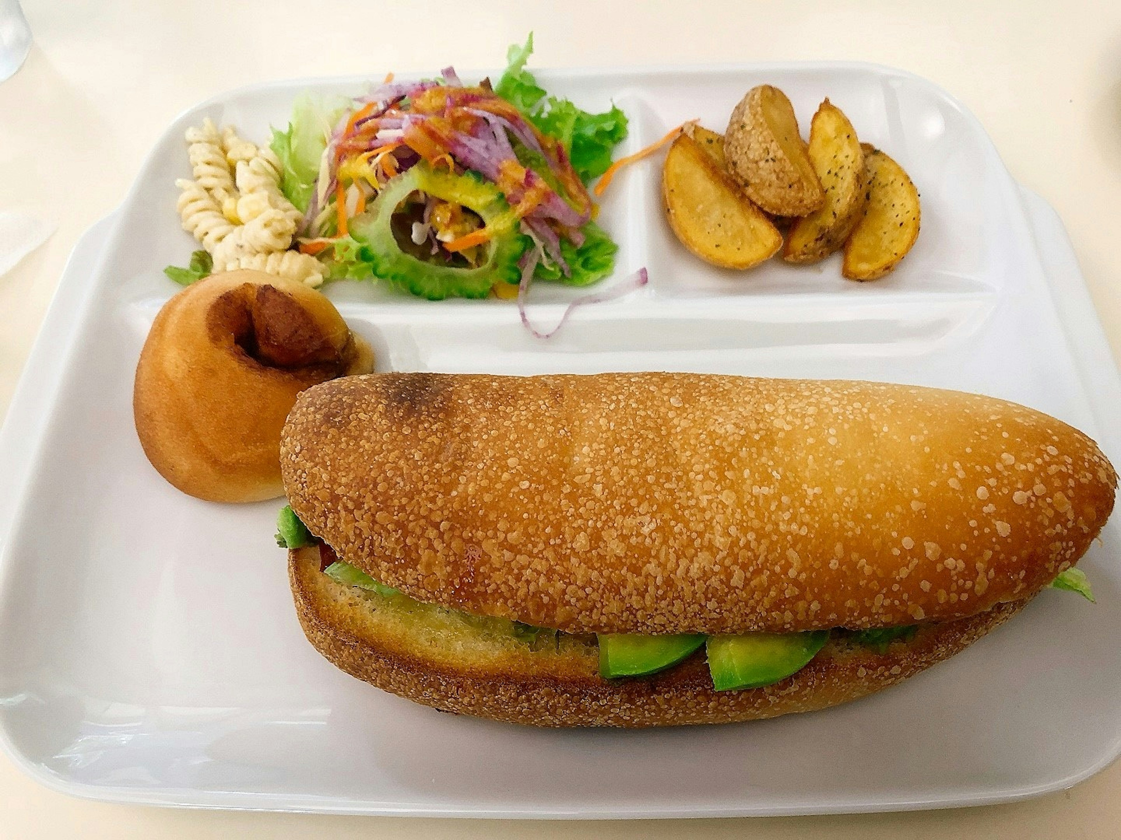 Plate with sandwich salad potato pastry