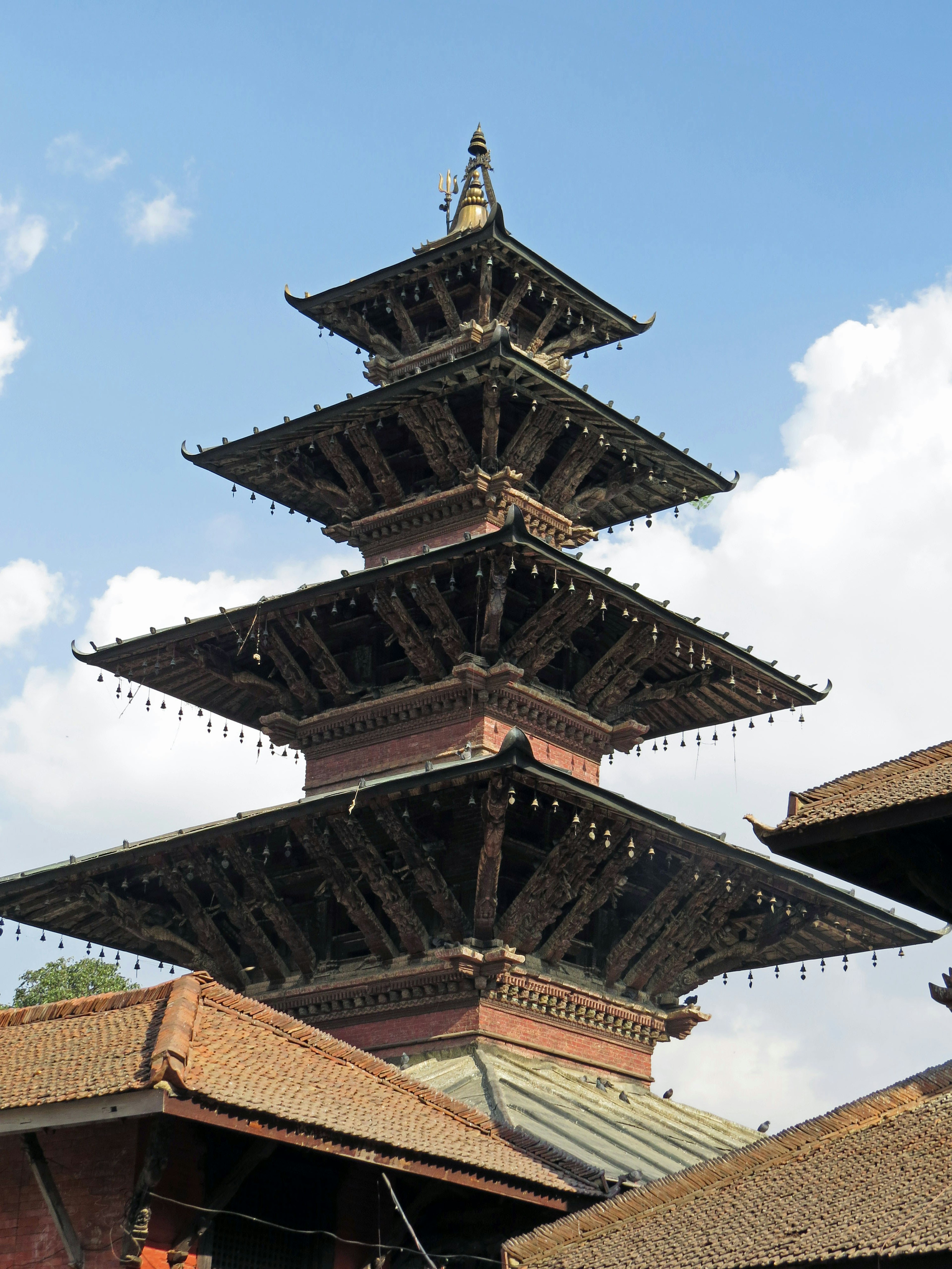 Traditional five-story pagoda in Nepal with blue sky and white clouds