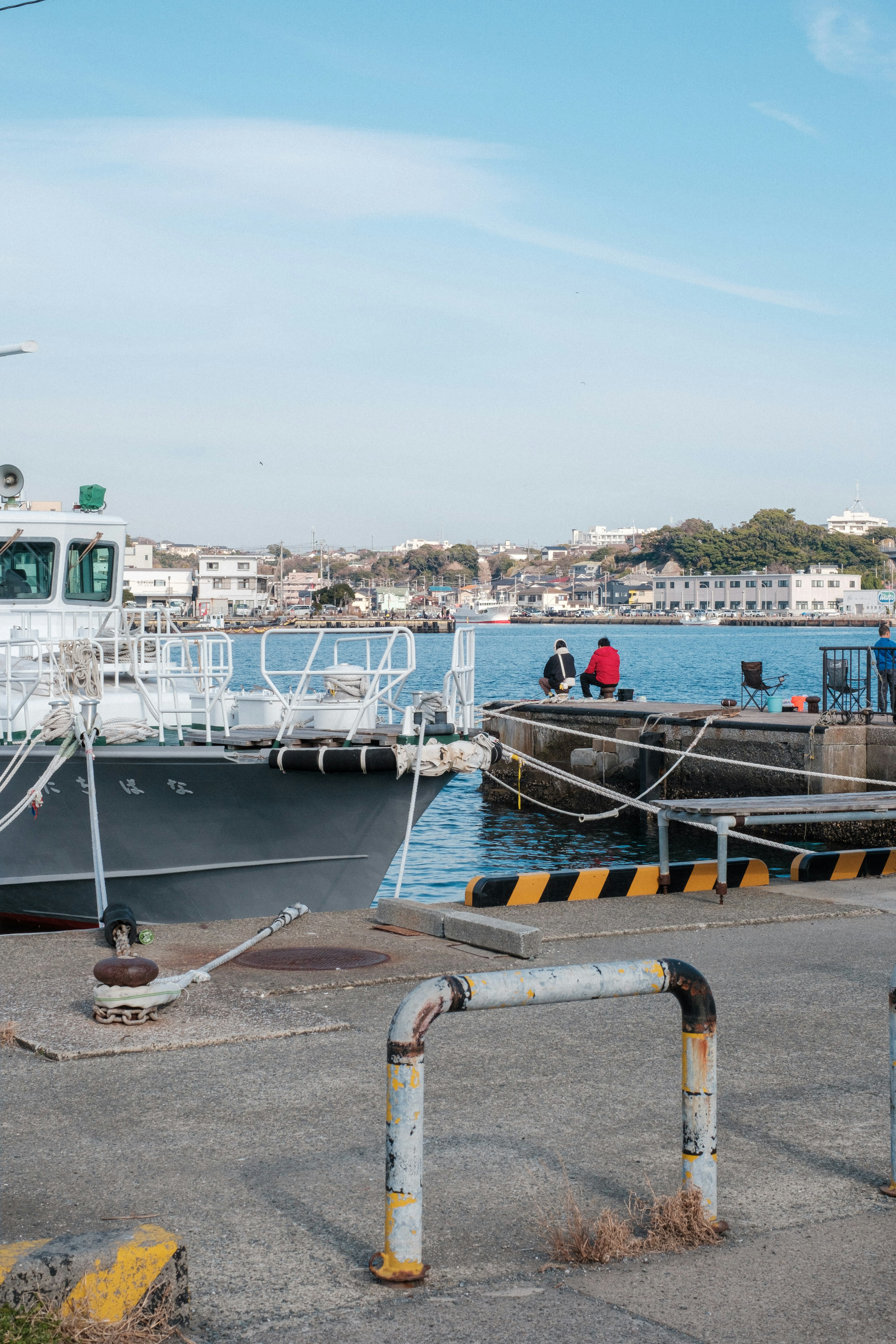 A docked boat at a harbor with a calm sea view