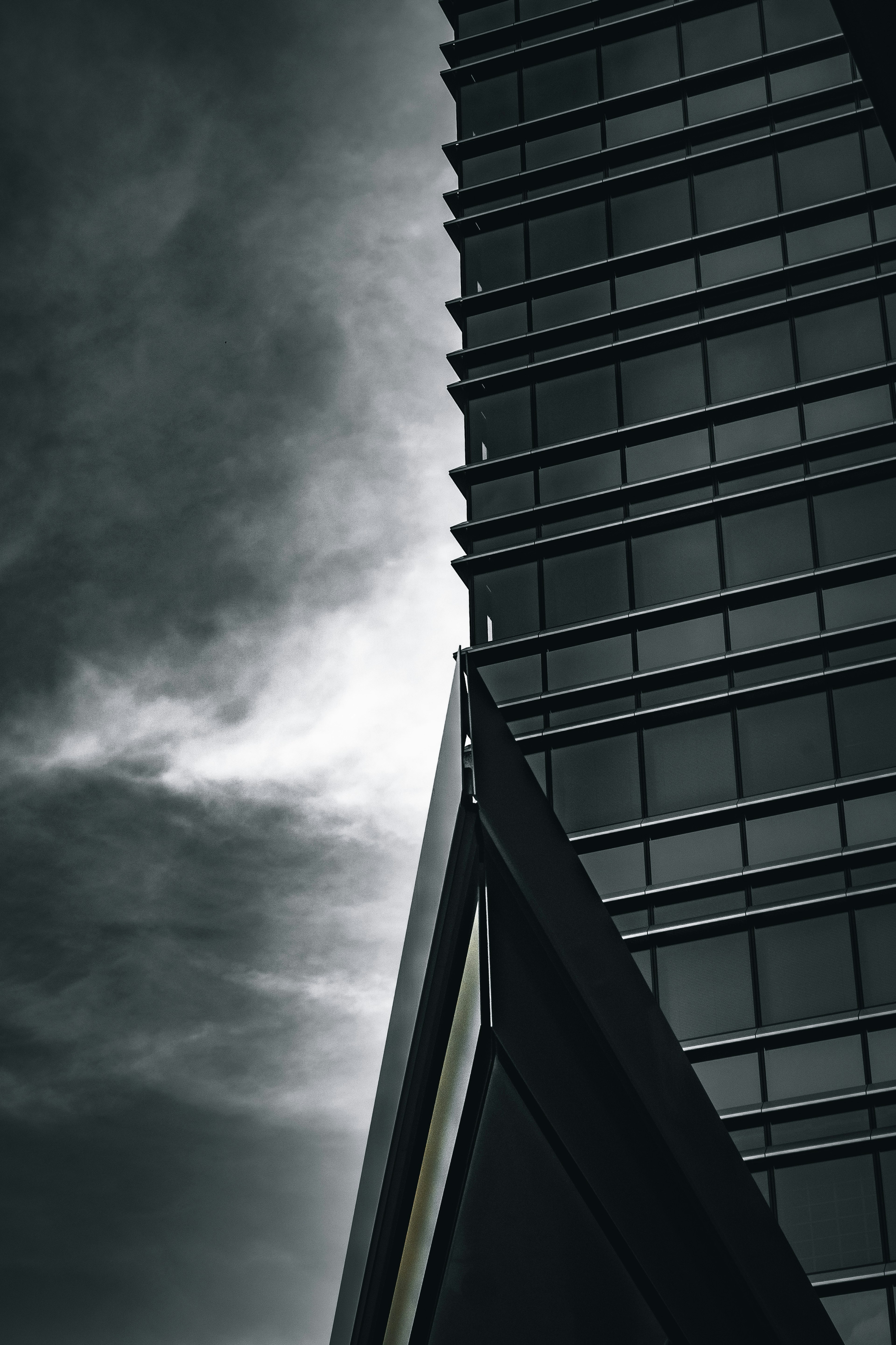 Side view of a skyscraper against a dark sky