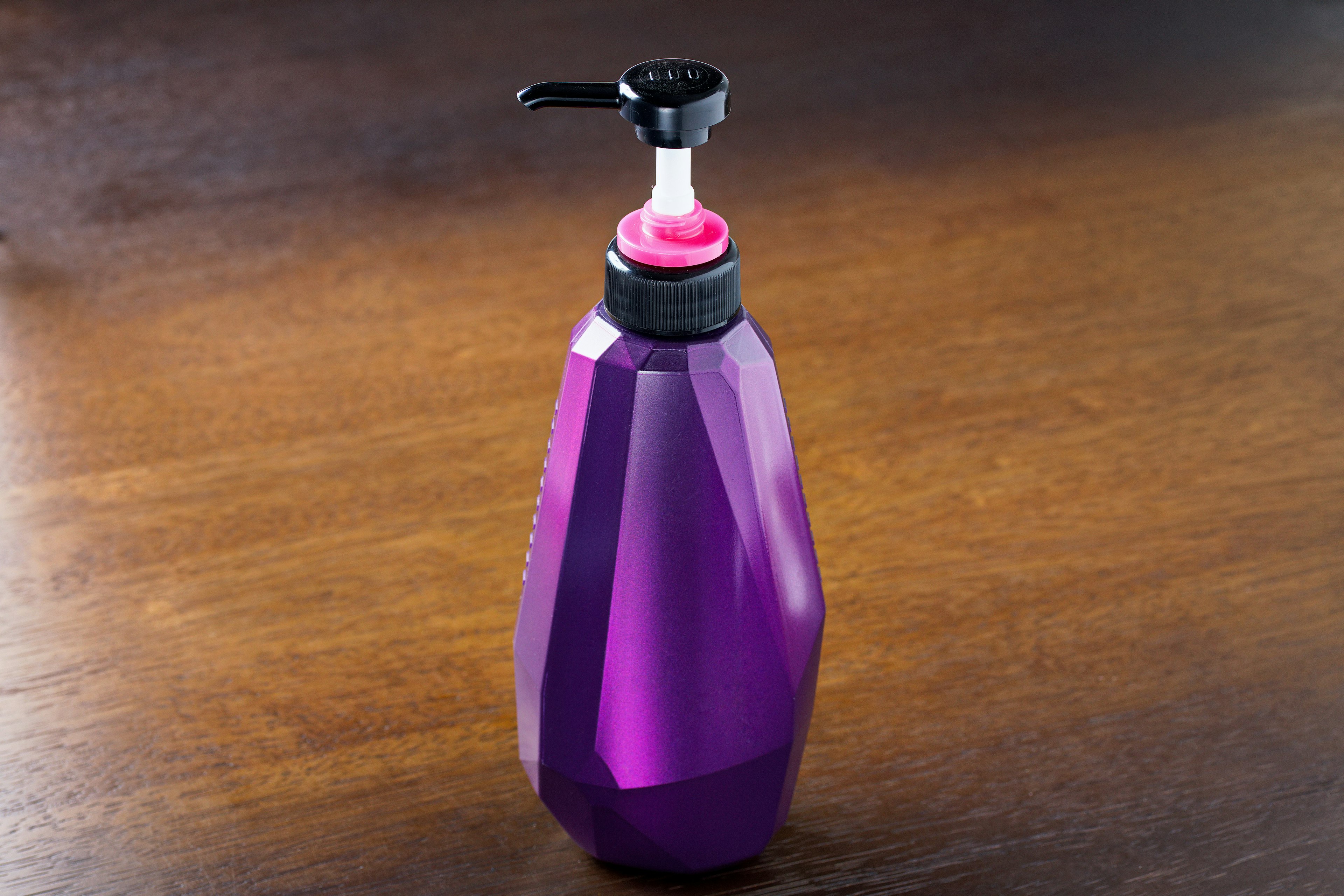 Purple bottle with a pump dispenser