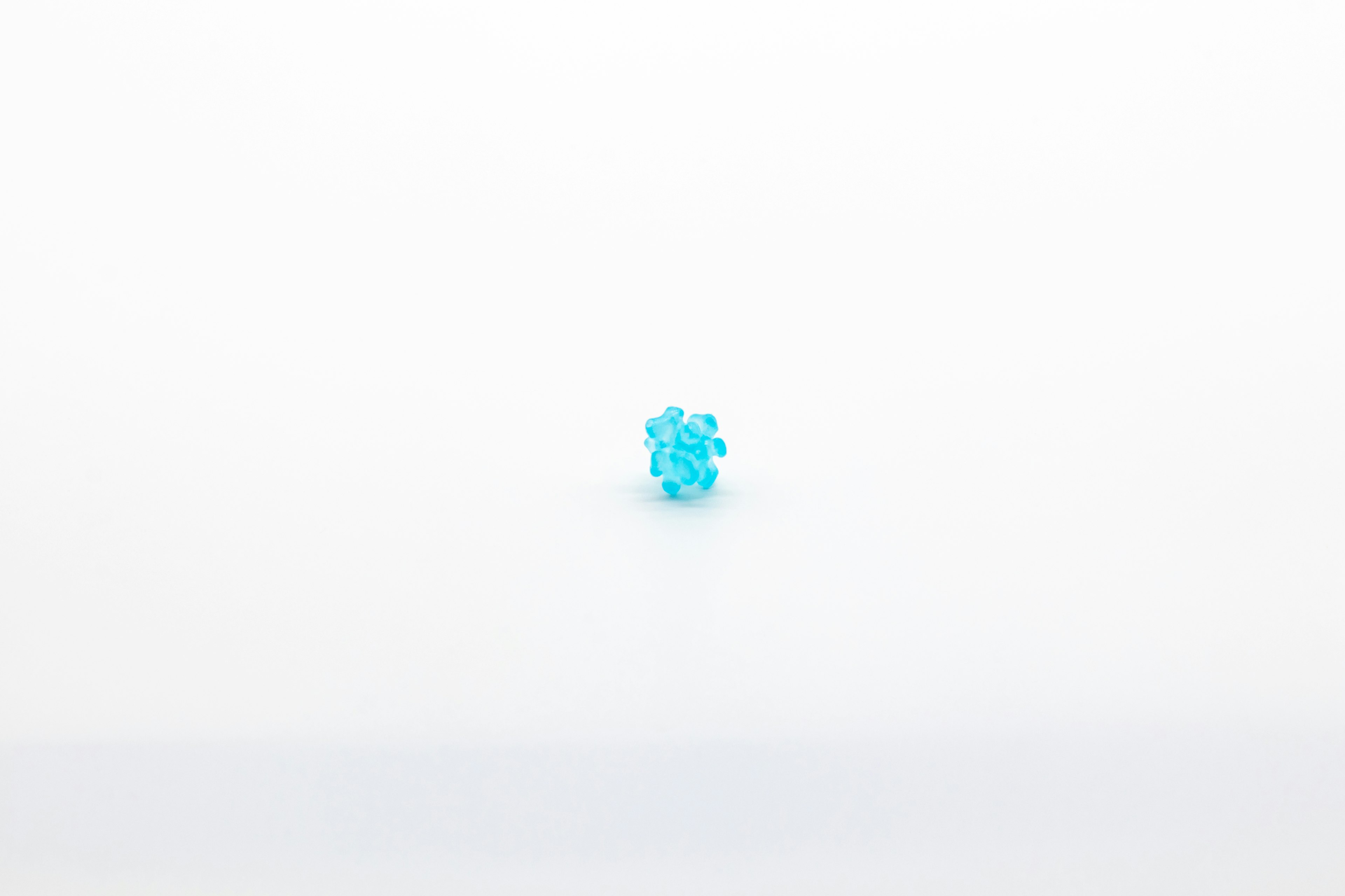 A blue gemstone placed on a white background