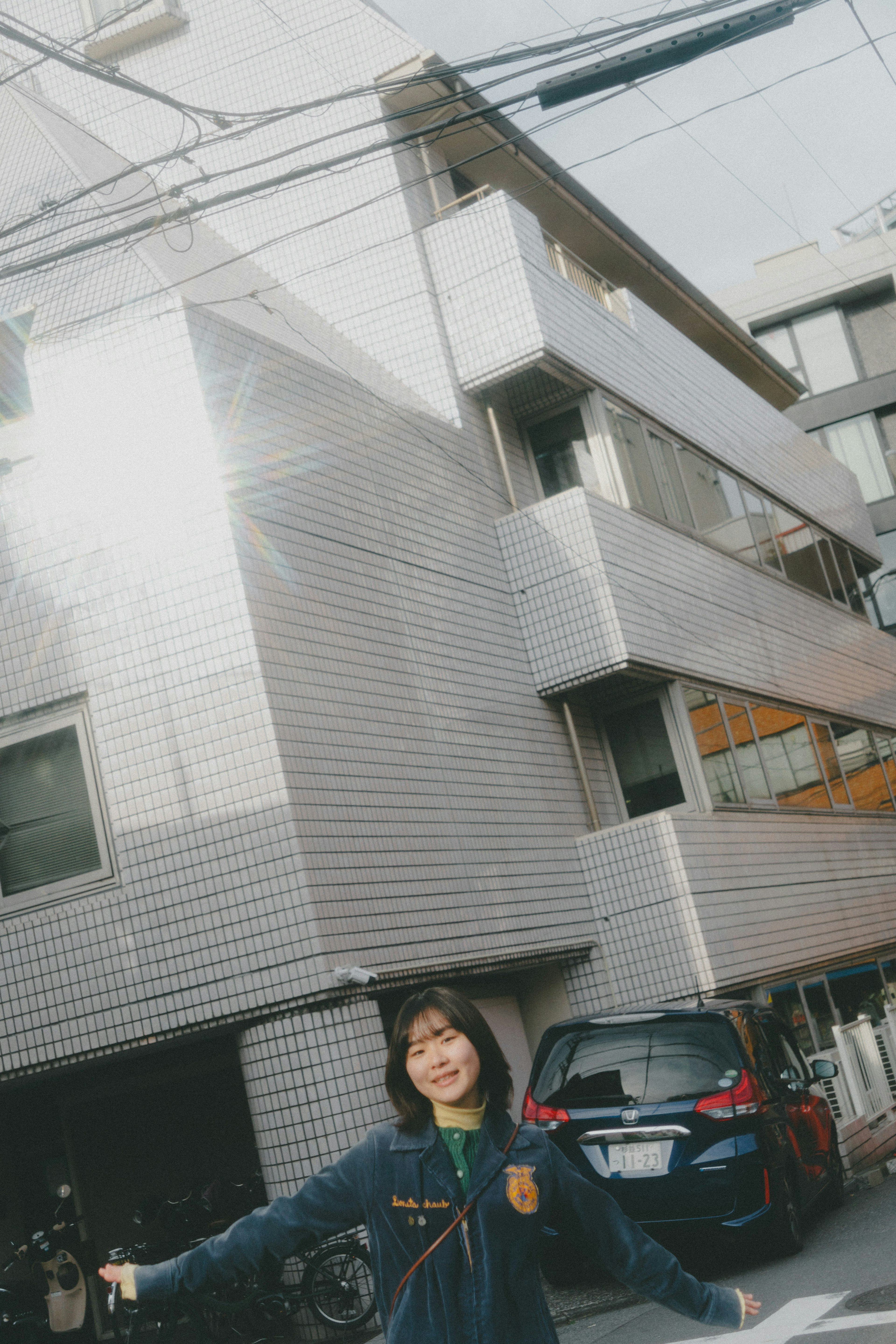 Young woman posing in front of a modern building