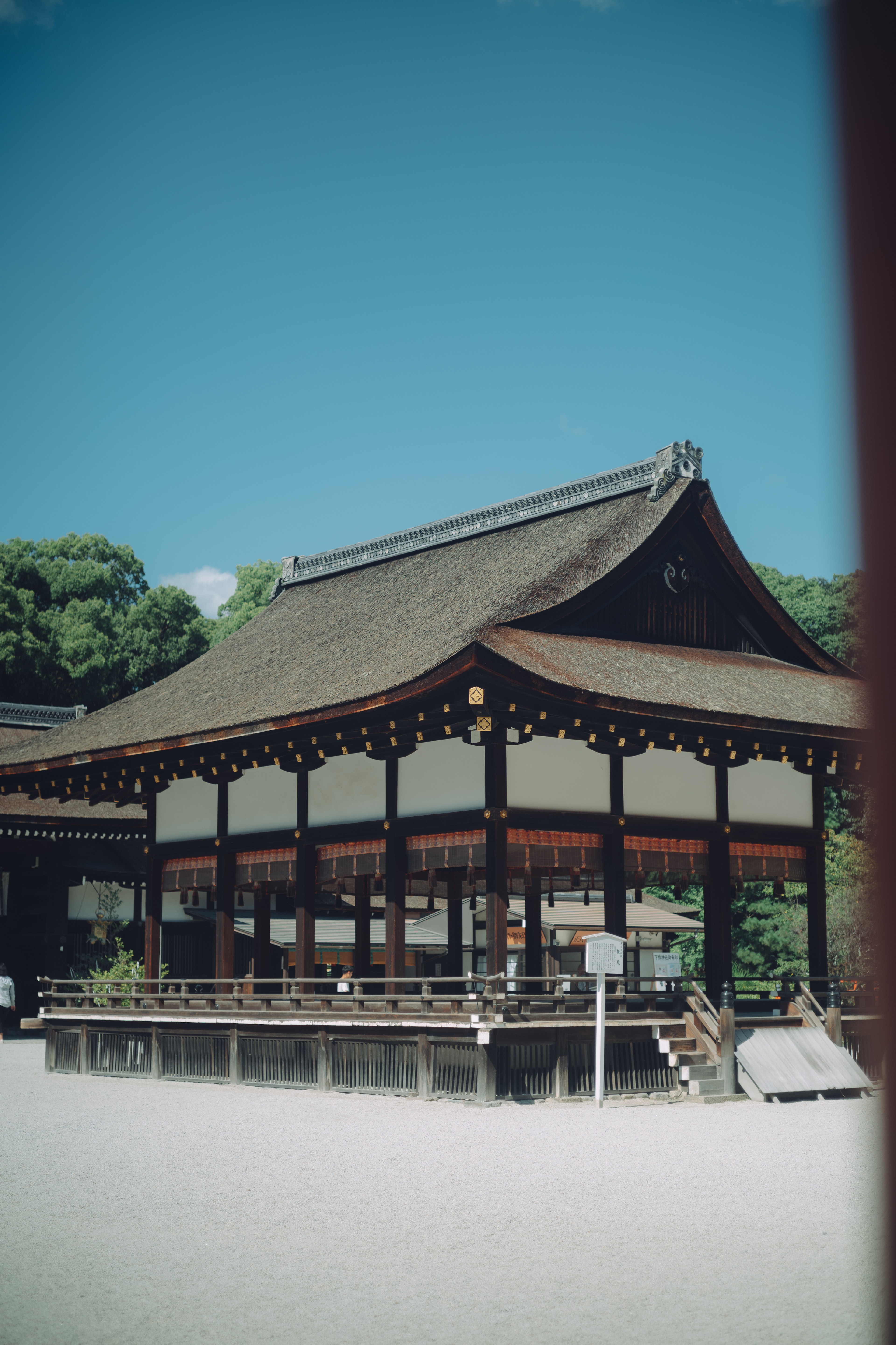 Traditional Japanese temple architecture under a clear blue sky